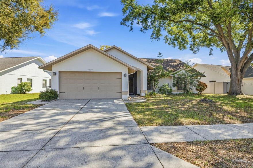 This solid concrete block single-story home is built to last and ready for easy living!  Inside, enjoy hassle-free ceramic tile flooring in the living spaces with newer carpeting in the bedrooms.  The newly remodeled kitchen shines with modern finishes and an eat-in area that overlooks the sparkling pool—perfect for meals with a view.   Open up the great room with pocket sliding glass doors that vanish to blend the living space seamlessly with the covered lanai for ultimate indoor-outdoor flow.  The star? A sparkling backyard pool under a fully screened enclosure—no bugs, no worries! The oversized, fully fenced yard gives pets and family tons of safe play space.  Located in a neighborhood with highly rated schools, and eligible for VA, FHA, conventional, or cash financing.  Homes with private screened pools move fast—don't miss this one.
