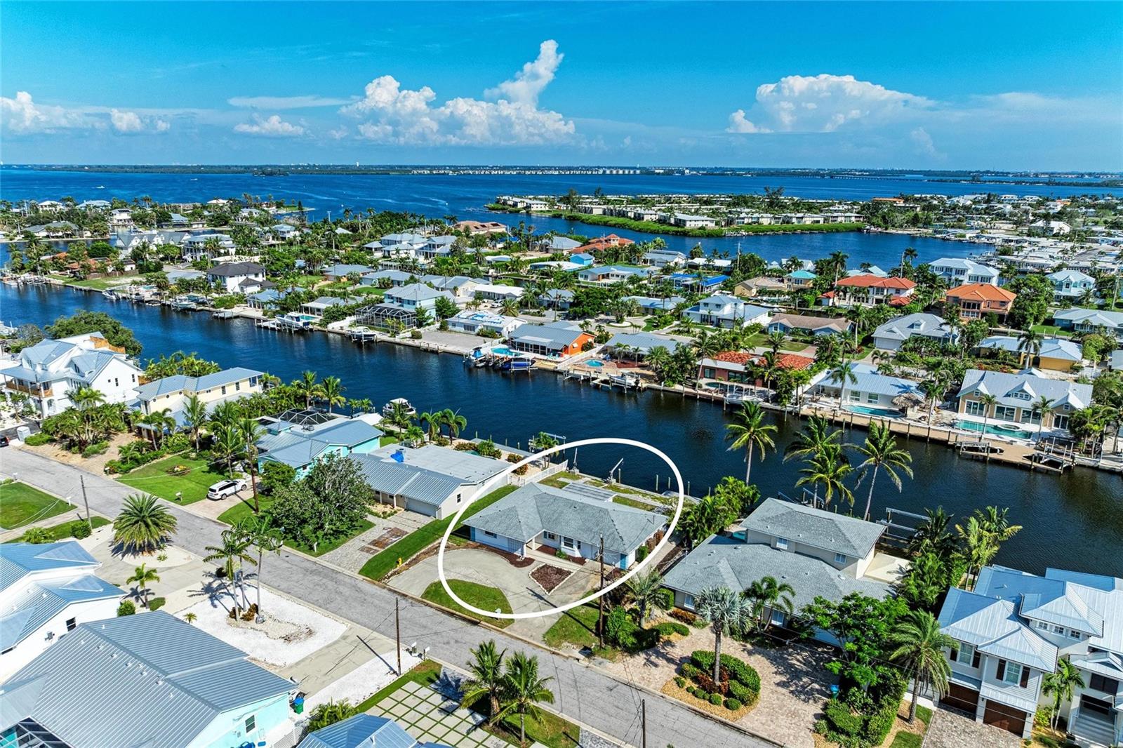 THE GRAND CANAL…Offering unlimited possibilities, this coveted location on Anna Maria Island features DEEP WATER access with NO FIXED BIDGES to Tampa Bay and the Gulf beyond. Add to that the additional privacy and amazing views you will enjoy looking across the 150 wide canal, plus more room to maneuver larger boats and you have a formula that ticks all the boxes. This home experienced storm damage but has been completely remediated by top notch professionals. A recently replaced roof and updated hurricane rated windows provide more than a little incentive to renovate. However, if you are looking to build the home of your dreams this location has exactly what you need to construct your own mini mansion. According to Holmes Beach Building Codes, this almost 9000 square foot lot will allow for new structures of up to 3500 square feet. A new cap on the seawall, newer dock and pilings, davits for jet skis and plenty of room for a pool and spa also add to the value calculations. It’s been said, “the only ceiling for value of a waterfront property is the size of the boat you can tie up to the dock!” If that is true, this fine property offers almost unlimited value potential. Oh, and did I mention you are a short bike or cart ride to amazing restaurants, quaint shops, the Island Theatre and of course pristine beaches perfect for an evening stroll with your significant. Why wait, call today and take the first step toward your future on Florida’s Gulf coast.