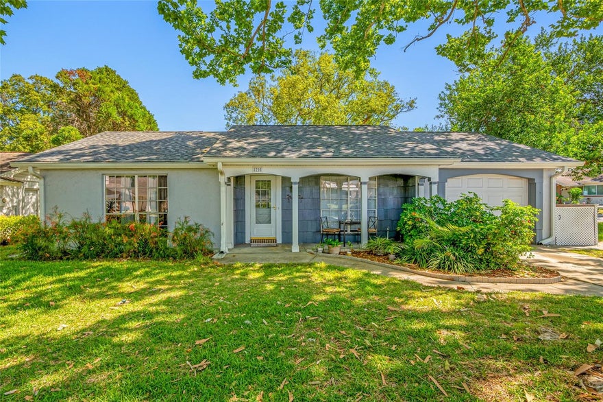 Come see this move-in ready 2 Bedroom, 2 Bath home located in the desirable golf course community of Beacon Woods.  Situated on corner lot with spacious fenced back yard perfect for entertaining, pets, or simply enjoying extra outdoor space with room to relax & play. NEW ROOF 2025.  Flexible floor plan includes a generous sized living room, open kitchen overlooking dining area, separate den/office, & mudroom leading from garage into kitchen.  One of this home's standout features is its 12x21 vinyl-enclosed screened porch, perfect for entertaining or enjoying your morning coffee. Laminate flooring throughout main living areas.   Beacon Woods features numerous community amenities including 18 hole golf course, heated community pool, clubhouse, tennis & pickleball courts, playground, & picnic areas.  Conveniently located near shopping, restaurants, parks including Hudson Beach Park, & easy access to US 19 & Suncoast Parkway.   Call today to schedule a private tour!