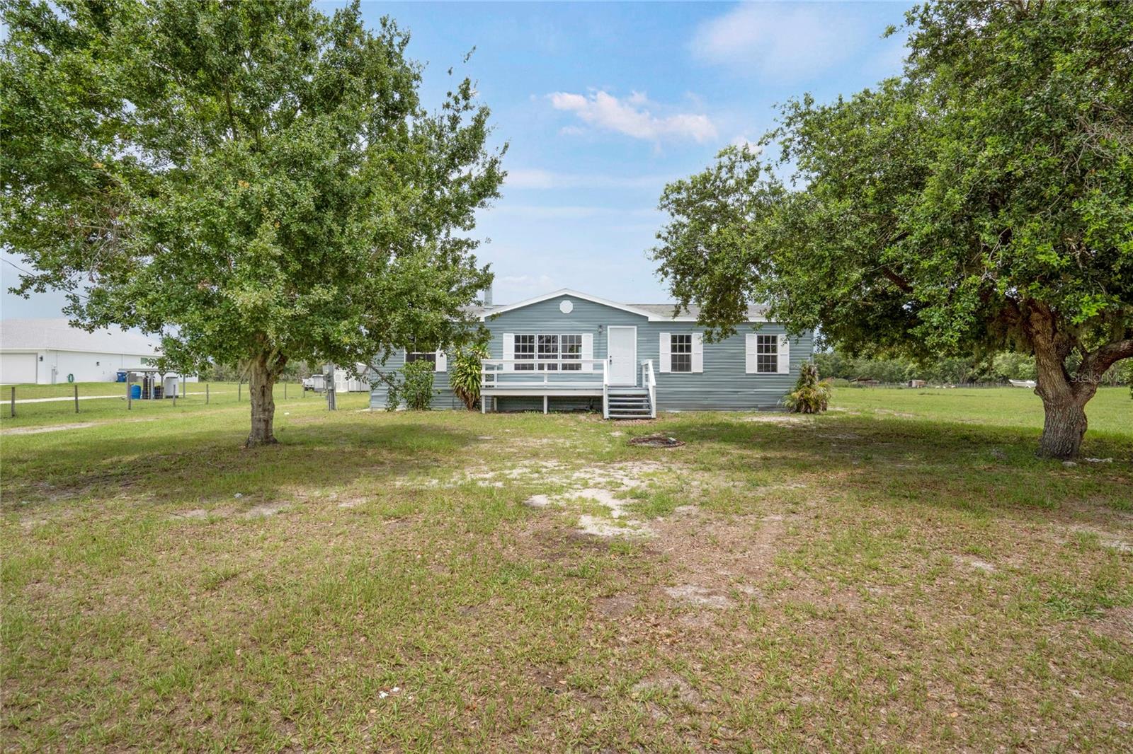 Welcome to peaceful Myakka City, where wide-open spaces meet the comforts of home!
This charming 3-bedroom, 2-bath country retreat is nestled on 5 serene acres, offering the perfect blend of privacy, functionality, and rural charm. Whether you're looking to settle into quiet country living or need space for your hobbies, animals, or outdoor adventures, this property has endless potential. Step inside to a bright, open floor plan with fresh interior and exterior paint, no carpeting, and thoughtful updates throughout—including new lighting, plumbing improvements, and hurricane-impact sliders. The heart of the home is the spacious living room with a beautiful fireplace centerpiece, ideal for cozy gatherings.
Off the living area, you'll find a large den to the right—perfect for a home office, playroom, or guest space—and the dining room and kitchen straight ahead. The kitchen flows effortlessly into the living space, making it ideal for entertaining.
The primary suite is located to the left of the home and features a spacious walk-in closet, his and hers sinks, a soaking tub, and a separate shower. On the opposite side of the split floorplan are two generously sized guest bedrooms and a full bathroom, with a conveniently located indoor laundry room just down the hall.
Enjoy your morning coffee on the updated front or back porch while taking in the tranquil views of the pond and expansive acreage. Out back, a massive 30x40 workshop (2019) offers the perfect setup for your RV, boat, toys, or next big project. There's also a separate shed with power, windows, and cabinetry—ideal for extra storage or a potential hobby space.
Outdoor enthusiasts will love the proximity to Duette Preserve, known for horseback riding, fishing, and wildlife viewing. You're also just minutes from the Manatee Gun & Archery Club. Best of all, this property is not in a flood zone, and there are no HOA or CDD fees—giving you the freedom to truly make it your own.
Don't miss the chance to own this slice of country paradise—schedule your private showing today and discover all the possibilities that await!
