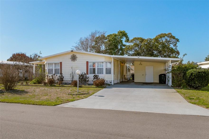 : Spacious double-wide in Barefoot Bay offering 1,604 sq ft of comfortable living on a spacious .17-acre lot! This 2-bedroom, 2-bath home features a very open floor plan with kitchen island, and a mix of tile, vinyl, and carpet flooring. Enjoy both a living room and family room, plus convenient interior laundry. Step outside to a private concrete pad surrounded by lush vegetation, along with a raised open front porch and enclosed glass porch--perfect for year-round enjoyment. Additional highlights include a double driveway, 2-car carport, and large utility shed for extra storage. Located in the desirable Haven Green Pinewood section with access to Barefoot Bay amenities.