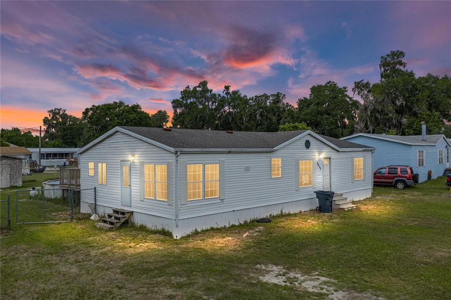 Welcome to this charming 3-bedroom, 2-bathroom manufactured home featuring a bright and open floor plan perfect for modern living. The expansive kitchen offers ample counter space and storage, seamlessly flowing into the main living areas for easy entertaining. The spacious primary suite includes a large en-suite bathroom with dual sinks, a walk-in shower, and a relaxing jacuzzi tub. Step outside to enjoy the generous backyard, complete with an above-ground pool connected to a deck—ideal for gatherings or quiet evenings at home. This property combines comfort, functionality, and outdoor enjoyment in one inviting package.