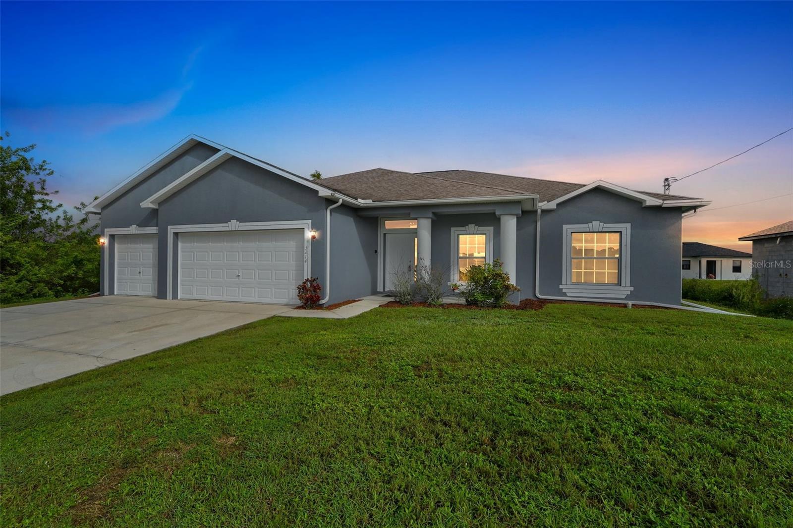 One or more photo(s) has been virtually staged. Welcome to the charming Lehigh Acres community and this outstanding home. With 4 bedrooms and 3 baths, all of your needs are covered. Starting outside, you'll immediately notice a fabulous concrete drive with plenty of additional parking. The 3 stall garage has room for tools, sports equipment and vehicles. Head inside to a bright and open floorplan full of warmth. You will appreciate the formal dining room at the front of the house and more private breakfast nook behind the perfectly located kitchen. Situated between your 2 dining areas, it makes cooking, serving, and entertaining a breeze. The stainless appliances and updated cabinetry look out over the living room and receive great natural light from the sunroom. This exceptional living space offers over 500 sq ft of functionality. Head out to the screened sunroom with concrete floor, perfect for peace & quiet and truly unwind from your day. Your favorite room in the new house might just be the owner's suite. With an en suite bath including a bathtub, shower, dual closest and dual sinks, you can sneak away and pamper yourself any time you like. There are 3 additional bedrooms, all with cozy new carpet. Two bedrooms share a jack and jill bath while the 3rd bedroom has a bath just outside the entrance. Welcome Home!