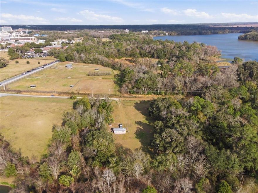 Rarely does a property combine such significant investment potential with the serene beauty of a private woodland retreat, all while situated just steps from the University of Florida’s South Campus. This expansive 1.5-acre parcel is ideally positioned across from the UF College of Veterinary Medicine, offering an incredible opportunity to reimagine the landscape into a premier estate. The land itself is a stunning open expanse framed by a majestic canopy of towering native Florida trees, providing a sense of seclusion and "Old Florida" charm that is nearly impossible to find so close to the university core. Adding immediate value is an existing income-producing secondary residence, currently tenant-occupied, providing a built-in revenue stream while you plan your vision for the site. You are perfectly placed to enjoy the best of Gainesville living; the property is minutes from the world-class shopping and dining at Butler Plaza and Celebration Pointe, the cultural exhibits of the Florida Museum of Natural History, and the pristine hiking trails of Bivens Arm Nature Park and Paynes Prairie. Whether you are looking to build a custom masterpiece in the shadow of the swamp or secure a high-value asset in one of the city’s most sought-after corridors, this property offers a rare canvas for growth and lifestyle.