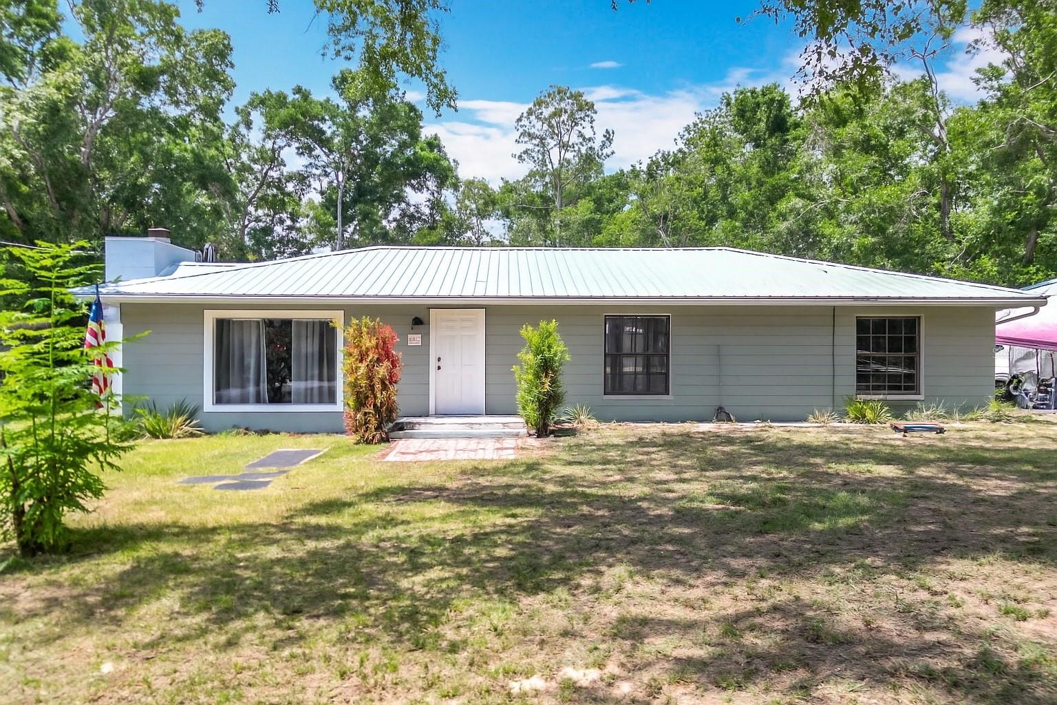 Short Sale. Summertime Home! Amazing concrete block POOL home,with a gorgeous wood-burning fireplace. Set on a Large 1.25 acre lot. This Gem offers the perfect indoor/outdoor lifestyle. The home is fully renovated with upgrades like new cabinets, granite, a deluxe stainless steel appliance suite, luxury faucets, premium paint in/out, and LED lighting. With a deep jacuzzi tub in one bathroom and an oversized walk-in shower in the master, nobody goes without. Tile and luxury vinyl flooring for an allergen-free easy-care home. This home has a all-new kitchen, and the most inviting living room. You’ll love the location on a dead-end street, peaceful neighborhood. Less than 2 miles to great K-12 schools,near downtown Bronson and the County Seat, and 30 minutes to Gainesville, but with low Levy County taxes. No HOA, no restrictions on parking your big toys, plenty of room for gardening or adding large workshop. This home comes with a nice-size shed and chicken coop. This home will not last at this price, Hurry1 Call and Schedule your Tour Today!