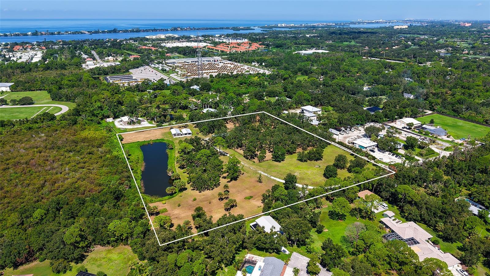 Truly a rare piece of Florida, a Natural Beauty! More than 11 acres in the heart of it all, west of I-75; Vacant land this size in Osprey’s sought-after Pine Ranch area is now very rare and seldom comes on the market.
Discover an incredible opportunity to own 11.69 acres of vacant land in a highly desirable and rapidly growing area! Whether you're an investor, developer, looking to build your dream home, or an equestrian retreat, this expansive property offers endless possibilities. Located at the end of a Cul-De-Sac, this high and dry property is fully fenced and has been cleared. Plenty of Palms, mature Oaks and Fruit trees remain from its days as a tree farm. The lot is simply gorgeous already as-is, with an oversized pond, newly custom built horse barn, several paddocks, a garage and air-conditioned workshop/studio. With this piece of land you also own Shotgun lane itself (29’ width) all the way from Bay St to the gated entrance. It is ready to build and has utilities you can hook into. Current zoning (RE1/RESIDENTIAL ESTATE (1UNIT/2ACRE) allows to build up to 5 homes. Despite its peaceful, country setting, the location could not be more convenient; The renowned Oaks Golf Club is just to the North and acclaimed Pine View High School abuts the property on the South, around the corner you can enjoy the Legacy Trail, Oscar Scherer State Park and Spanish Point, close to shopping, dining, famous Siesta Key & Nokomis beaches, vibrant Sarasota, charming Venice, top-rated schools and health care providers.
Whether you're an investor seeking lucrative potential or someone eager to build a personal dream estate this prime land presents an unmatched opportunity in a high demand area with strong appreciation of land values. No matter your choice of use, beautiful nature and serenity will be yours. Call today for a showing.