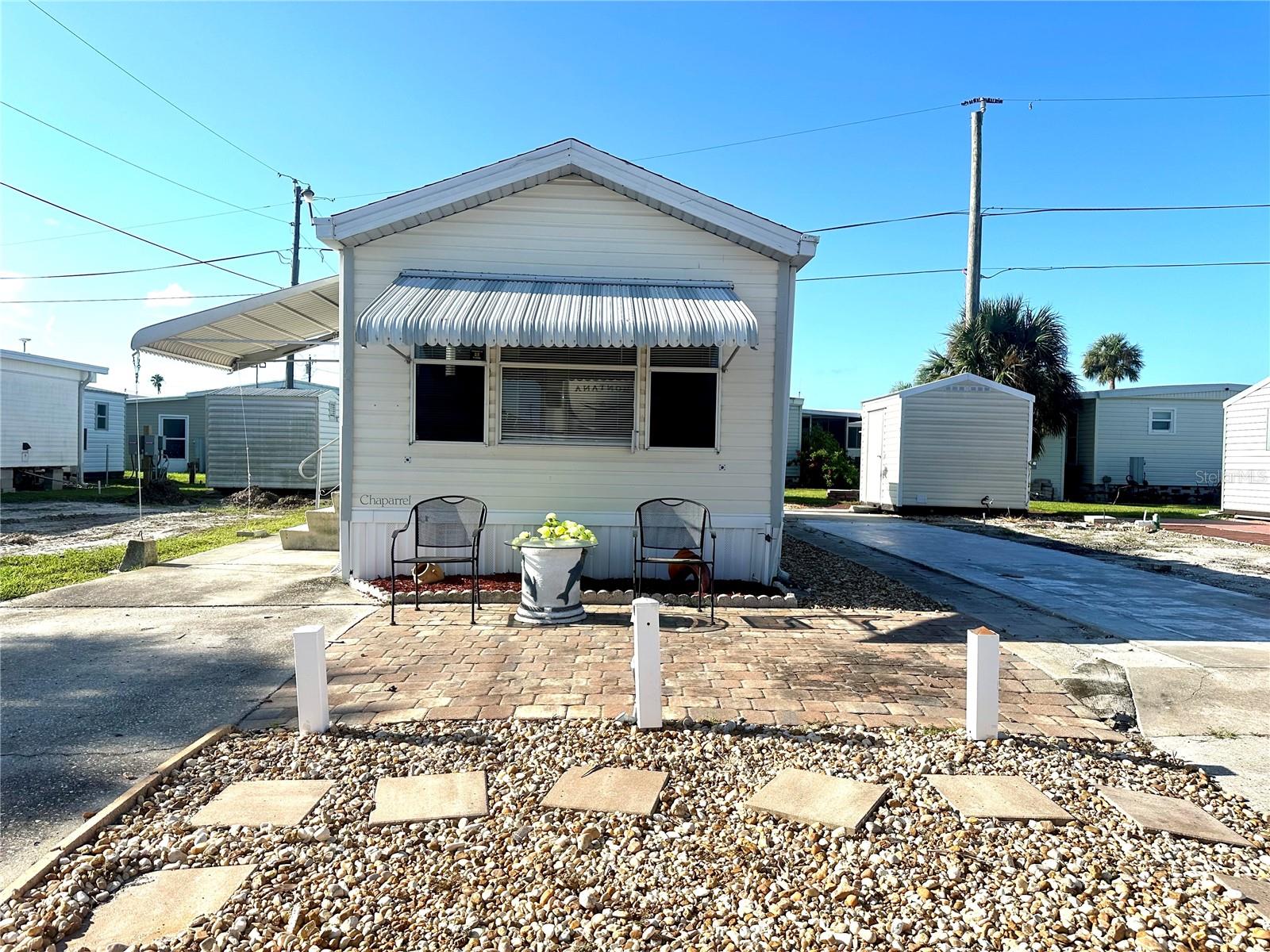 UNIQUE opportunity to grab this IMPECCABLE TURNED KEY - MOVE IN READY PARK MODEL IN TROPIC ISLES! A 55+ Resident Owned Waterfront community. This unit offers 1 bed, 1 bath and an spacious living room. A nice back patio along with a large shed. This home features a spacious paved front sitting area—perfect for enjoying your favorite afternoon drink while soaking in the warm community vibes. Whether you're greeting neighbors, lounging in the sun, or parking your golf cart, this thoughtfully designed space offers both charm and functionality. Tropic Isles offers an array of amenities and endless activities for your enjoyment. Recreational facilities include a full service MARINA and BAIT SHOP, social rooms, shuffleboards and so much more!
