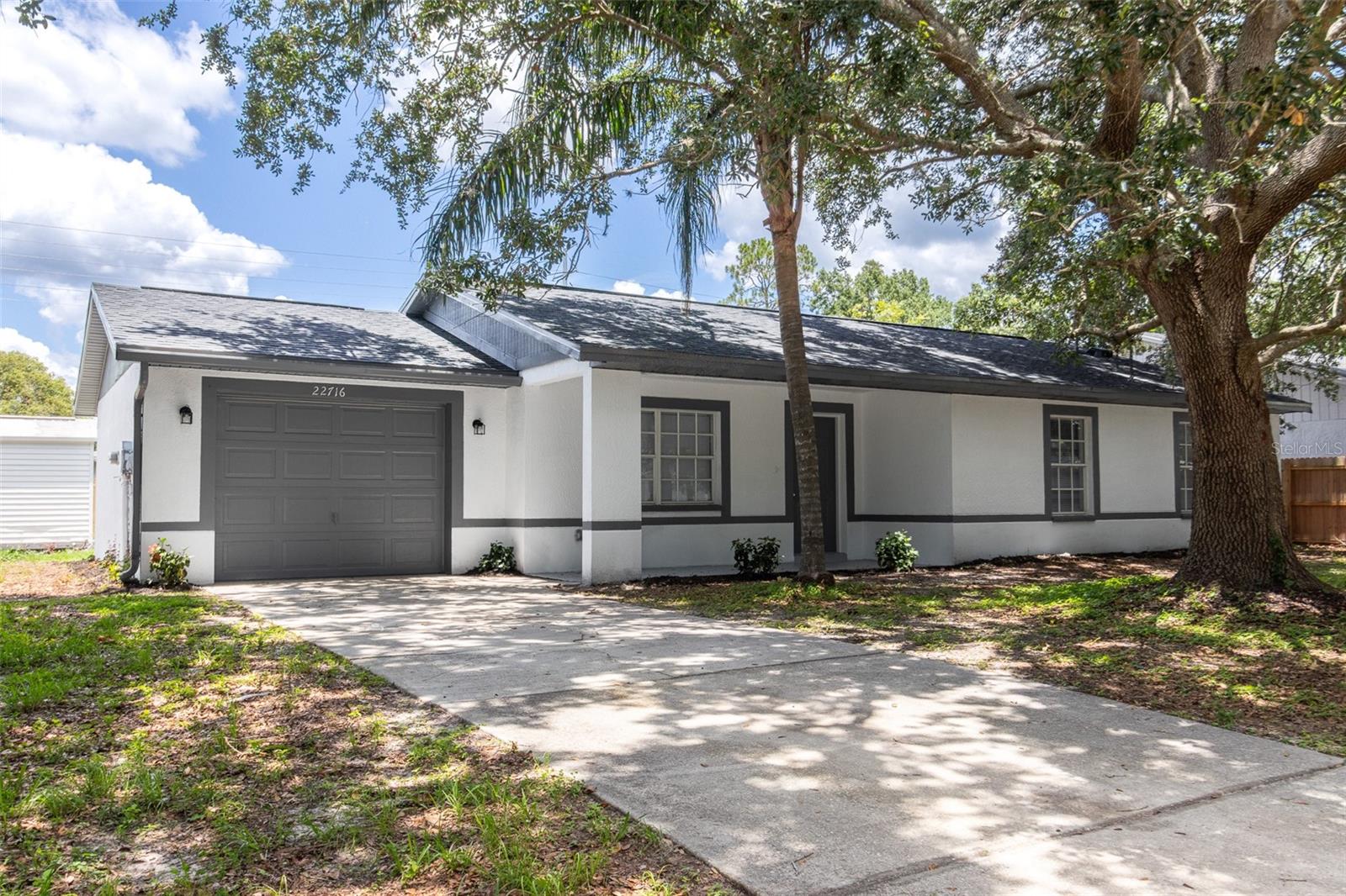 This is where Florida charm meets a full modern refresh — a bright, stylish home tucked into one of Land O’ Lakes’ most loved communities: Lake Padgett. From the moment you pull in, it’s clear this home has been given new life, inside and out.
Step through the door and feel the difference. The floors are brand new, stretching through a fresh, open layout wrapped in soft, modern tones. Baseboards tie it all together, clean and crisp against freshly painted walls. The kitchen is completely rebuilt — brand new appliances, quartz countertops that sparkle in natural light, and a flow that makes both cooking and entertaining feel effortless.
Bathrooms have been fully updated with sleek fixtures and finishes that bring calm and comfort. Everything here feels new — because it is.
Step out back to a screened-in patio made for morning coffee or lazy Florida evenings, with a spacious shed nearby ready for tools, toys, or weekend projects. The lot is open, the layout is easy, and the lifestyle is exactly what Lake Padgett is known for.
Perfectly placed right off State Road 56 and just down the street from 41, you’re minutes to Wesley Chapel, Lutz, and an easy shot into Tampa. I-75 is just ten minutes away, but peace and quiet stay right where you are.
Freshly remodeled, thoughtfully designed, and ready for whatever comes next