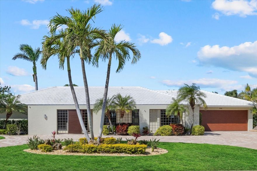 Ideally located within the highly-sought-after neighborhood of Bird Key, this updated garden home offers a refreshed living experience that embraces the quintessential Florida charm you have been looking for. Upon entering, you are welcomed by an abundance of natural light that highlights the beautiful finishes that have been selected for this home. Featuring 4 bedrooms, 3 bathrooms, dining room, family room and a living room there is plenty of space to entertain and unwind. At the heart of the home is the kitchen which features premium maple cabinets by Campbell Cabinetry, a gas cooktop, granite countertops and stainless steel appliances. The primary suite is a serene retreat with his and her closets, wood flooring, and sliders that open directly to an outdoor oasis. Once outside, you wall want to relax and enjoy the heated saltwater pool and lush garden view. Further enhancing the usability of the space, there is a recently added lanai cage (2022) and a covered entertaining area complete with travertine flooring the flows seamlessly into the living room creating a true indoor / outdoor living space. Nestled quietly at the back of the home, you will discover a large bedroom that is approximately the same size as the primary suite, complete with a private bathroom, ample closet space, and separate sliders leading to the pool area. The family room, also offering direct access to the pool, showcases soaring cathedral ceilings and custom-built cabinetry. For those who enjoy working in the garage, this home offers built-in Newage garage cabinets and work top as well as epoxy flooring. And for peace of mind, the entire home features PGT impact windows and sliders (2022), PGT impact exterior doors (2022), a newer tile roof (2021), impact-resistant garage door (2019), and a security system with cameras. Other notable features of this home include: Halo whole-house water filtration system, SubZero wine fridge, mature landscaping, circular driveway, and more. Located between downtown Sarasota and St. Armand’s Lido Key, Bird Key is coveted for its convenient location to nearby beaches, shops, and restaurants while still maintaining a sense of privacy. Bird Key Yacht Club is also located on this residential island where members enjoy fine dining, a private club, social activities, a fitness center, tennis courts, and boat slips.