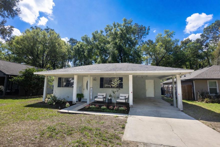 Welcome to this charming 2-bedroom, 2-bath home located in the peaceful GOLF CART–friendly community of Mount Plymouth. This neighborhood offers the perfect blend of a quiet rural vibe while still being conveniently close to everyday essentials and local attractions.
Just a 15-minute drive to the charming downtown of MOUNT DORA, you’ll enjoy boutique shopping, local dining, parks, and community events. Outdoor lovers will also appreciate being just 10 minutes from KELLY PARK ROCK SPRINGS, known for its crystal-clear water and relaxing natural lazy river. For commuters, you’ll love the easy access to Florida State Road 429, making travel to Orlando a CONVENIENT 35-minute drive.

Inside, the home features an OPEN-CONCEPT layout where the kitchen and dining area flow seamlessly into the living room, perfect for entertaining guests or enjoying cozy evenings at home. The stylish kitchen features CONCRETE COUNTERTOPS, tiled backsplash, and STAINLESS-STEELE APPLIANCES including a dishwasher, stove, and microwave, combining modern updates with functional design. The primary bedroom suite offers a warm and stylish retreat, featuring custom sliding BARN DOORS that lead into the beautifully updated ensuite bathroom featuring a WALK-IN SHOWER and DUAL SINKS. The primary bedroom also includes a 5x5 walk-in closet with matching barn doors for added character and storage.

The second bedroom is generously sized, while the second bathroom has also been tastefully updated, providing comfort and style for guests or family members.

Sliding glass doors from both the living room and primary bedroom open into a 8 x 28 ENCLOSED LANAI with a convenient laundry closet. This back porch is surrounded by LARGE WINDOWS overlooking a lush backyard filled with mature trees and beautiful greenery. It’s the perfect place to relax, sip your morning coffee, and enjoy the peaceful natural scenery.
Recent UPDATES include AC SYSTEM was replaced 3 years ago, HYBRID WATER HEATER (3 years old), ROOF replaced in 2018, UPDATED Electrical panel. 

The home also features solar panels with a SMART METER, keeping the average electric bill around just $12/MONTH. The solar panel payment is $172/MONTH, offering excellent energy efficiency and long-term savings. Additionally, fiber optic internet is available in this area, which makes it ideal for remote work, streaming, and modern connectivity.

If you’re looking for a home that offers peaceful living, nature nearby, and convenient access to the city, this Mount Plymouth gem is one you won’t want to miss.