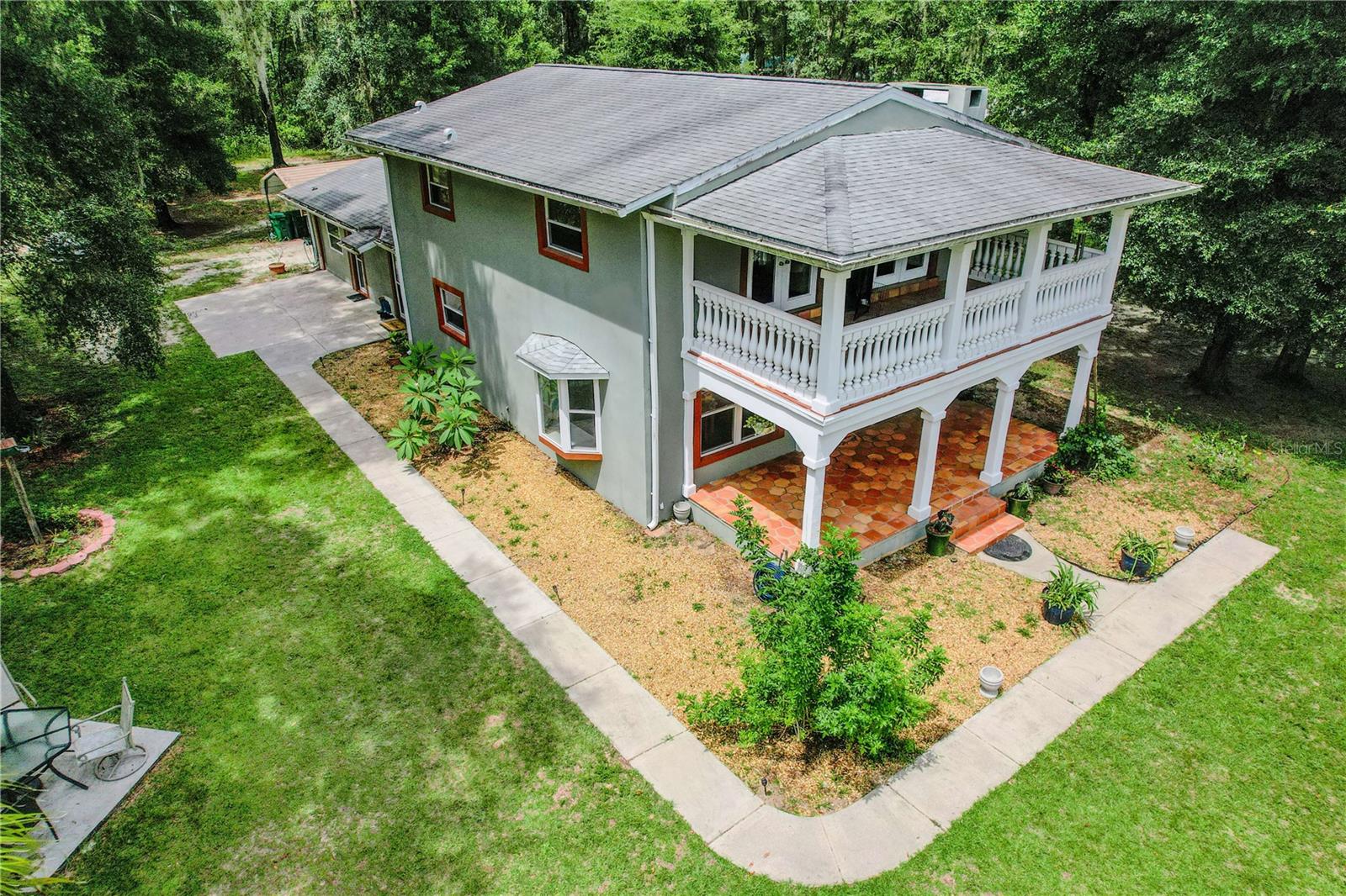 Welcome to your Florida dream farmhouse—a stunning blend of rustic charm and modern comfort nestled on 5 fully fenced acres of picturesque countryside. This custom-built 4-bedroom, 2-bathroom home offers an expansive 2,865 sq ft of beautifully designed living space, thoughtfully updated in a fresh, contemporary farmhouse style. As you step inside, you're greeted by a bright and inviting interior with luxury tile flooring throughout, a stone wood-burning fireplace, and a spacious great room that flows seamlessly into a formal dining area—perfect for entertaining. The chef’s kitchen boasts granite countertops, stainless steel appliances, wood cabinetry, and a breakfast bar, ideal for family meals and gatherings. The main level features a guest bedroom or office, plus a generous l/mud room with side entry—perfect for dropping boots after working the land. Upstairs, you'll find three additional bedrooms, including an oversized 15x30 master bedroom complete with a 10x25 private balcony overlooking your very own rural paradise. Outdoors, the lifestyle you’ve dreamed of awaits: - 30x60 Metal Barn (1,800 sq ft) with sealed concrete pad, electric, 3 roll-up doors (two 10', one 8')—ideal for boats, RVs, vehicles, or a workshop, holds up to 5 vehicles - 12x12 Horse Stall with room to expand - 20x20 Heavy-Duty Carport - Chicken coops, mature shade trees, fully fenced, and irrigation stubbed throughout - Garden areas, fruit trees, and open space to roam, ride, or relax - Large covered front porch 10x25 This unique property is just minutes from downtown Inverness and Brooksville, with convenient access to Tampa, Orlando airports, and Florida’s top nature preserves and equestrian trails, including the Withlacoochee State Forest and Croom Wildlife Management Area. Nearby Floral City Park offers pickleball courts, disc golf course and new playscape. Within easy driving distance are Pasco-Hernando State College North Campus in Brooksville, College of Central Florida Citrus Campus in Lecanto, Saint Leo University near Dade City, and University of Florida in Gainsville. Whether you’re an equestrian, hobby farmer, or simply seeking the peace of country living with proximity to modern amenities, this home offers a rare opportunity to own a fully equipped, move-in ready estate that checks every box including Spectrum high-speed WiFi. Schedule your private tour today and experience the serenity, space, and style you’ve been searching for!