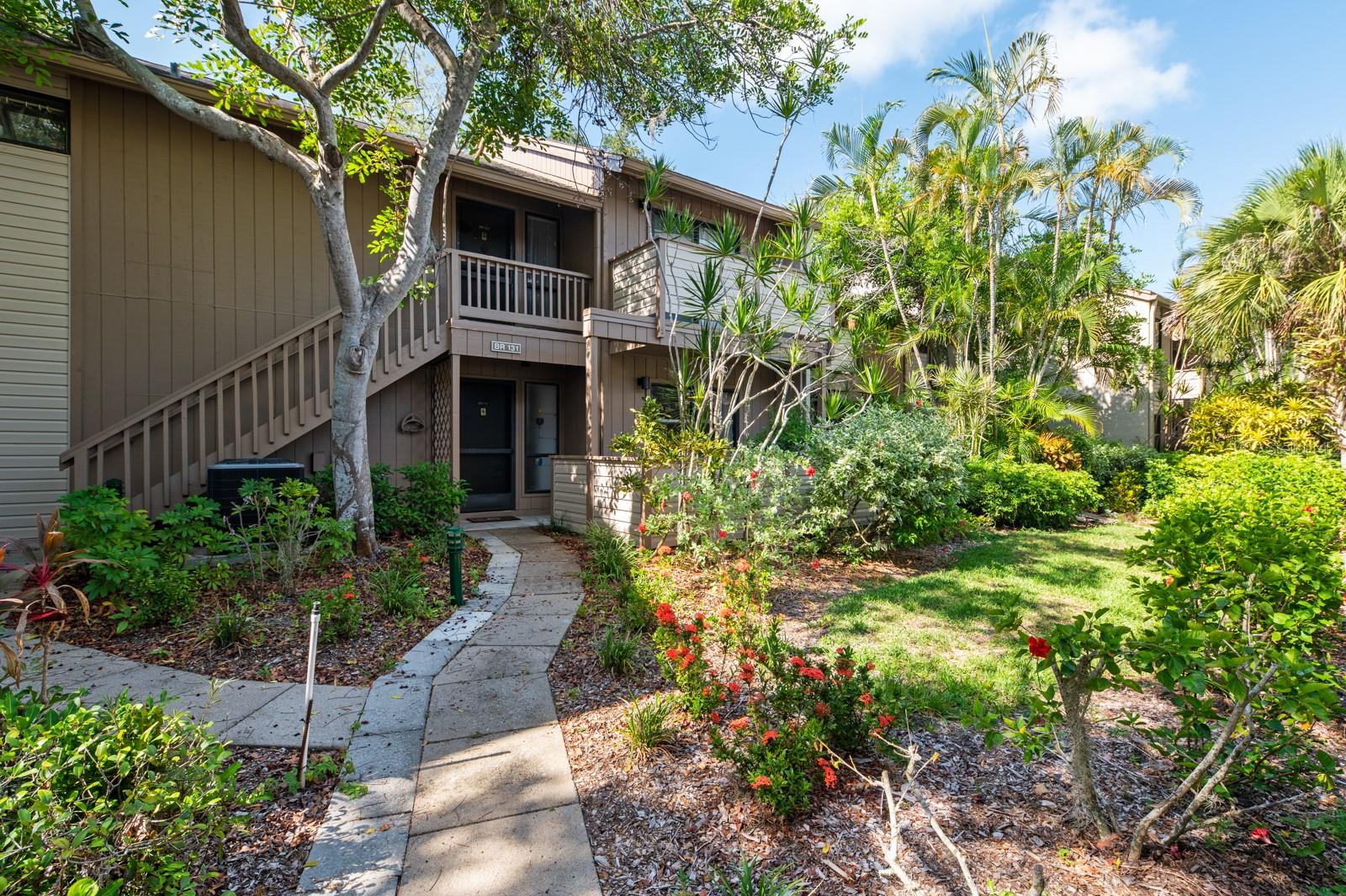 GROUND FLOOR two bedroom/two bath condo with an open living room which flows into the glass enclosed Florida room with private wooded rear view, creating a marvelous space for entertaining friends. The kitchen features ample cabinets and counter space and is conveniently located off the dining room along with an outside courtyard area in which to entertain or relax and read quietly. Retreat in the oversized master suite offering a large walk-in closet and sliding glass doors to the Florida room.  Pelican Cove is a deed restricted gated community located next to Little Sarasota Bay and short distance to downtown Sarasota and Siesta Key beaches. Pelican Grove is situated on 75 acres of tropical lush paradise with deep water marina with direct access to the bay, 87 boat slips, kayak launch, 6 heated pools, 4 tennis courts, 3 clubhouses, kayaking, fishing pier, fitness, music/performing arts, exercise room, full calendar loaded with social activities and roadways covered by canopy of majestic trees. Just move-in and start enjoying the Florida lifestyle.