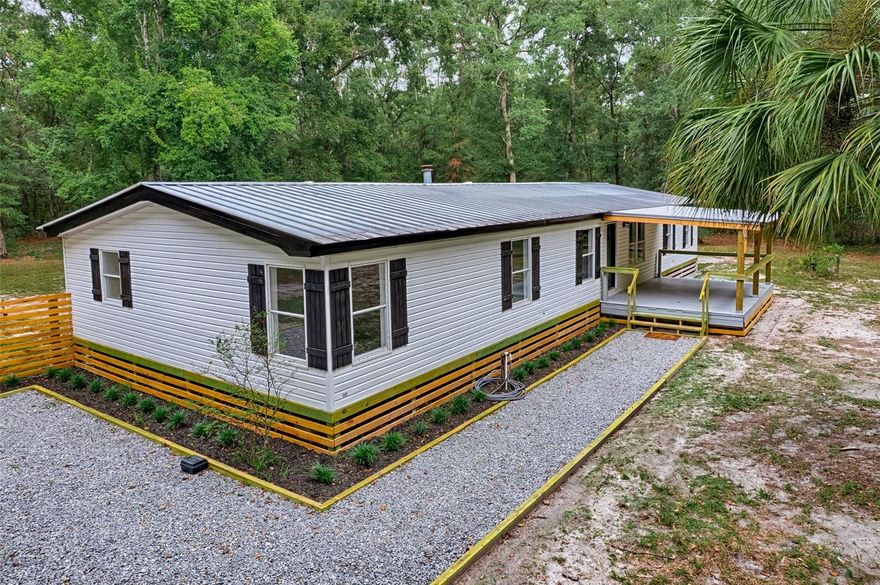 CHIEFLAND, FL ~ 3 bed/2 bath (2 bonus rooms would make it 5 bedrooms!) All rooms are spacious, 1890 sf is heated/cooled but a whopping 2246 sf under roof with the addition of the front and rear covered porches. Plenty of room to roam and play on 5 acres that is mostly fenced with a gated front entry. Renovations and upgrades have been done to perfection. The primary bathroom has a combo tub/shower that has been custom tiled & there is a separate makeup vanity, along with dual sinks, plenty of counter space, & a linen closet. Primary bedroom of course has a large walk-in closet. The family room is oversized 25 x 26 with a vaulted ceiling and has a wood-burning fireplace. A butcher block breakfast bar separates the family room and kitchen. Kitchen approx 12x13 has lots of wood cabinets, plenty of counter space for food preparation, a custom Subway tile backsplash, and a very roomy walk-in pantry. Indoor laundry room is off the kitchen with access from the rear covered porch entry. If you don't use the two bonus rooms as bedrooms, they could be used for a variety of other purposes such as office, craft room, home gym, etc. Central A/C & heating vents are in the ceiling & NOT the floor which saves on your electric bill & no aggravating ductwork to deal with. The five acres is lightly wooded with a path meandering to the back of the property which fronts on NW 156 St making it convenient for another entry to the property from the rear. Property is high and dry, NOT in a flood zone according to FEMA website. GREAT rural location on a paved road not far from town and close to multiple freshwater springs, and numerous boat ramps on the Suwannee River. There is a LOT to love about this home and property. See it today and judge for yourself.