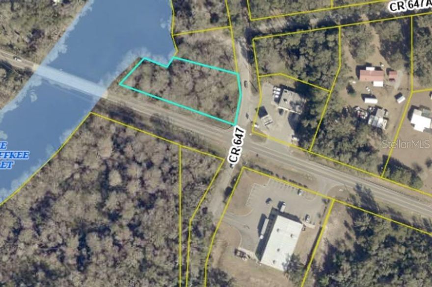 Riverfront opportunity!!This wooded corner lot offers just over half an acre of natural beauty with direct access to one of Florida’s most scenic rivers. Towering trees provide shade and privacy, creating the perfect setting to build your dream river retreat, weekend getaway, or full-time residence surrounded by nature. Enjoy the peaceful sounds of the water while still being just minutes from town—with a gas station and retail store conveniently located across the street and everyday amenities only a short drive away. Whether you’re looking to kayak from your backyard, relax under the trees, or invest in a prime riverfront location, this property offers the ideal blend of seclusion and accessibility.