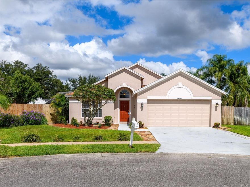 4/2/2 Beautiful Inland "Bradford" Model Home in the Oak Grove Subdivision of New Tampa/Lutz near Tampa Premium Outlet Mall. This home is located on a premium cul-de-sac lot with lush landscaping. Fresh new interior paint, freshly painted exterior front door and painted garage floor. Fenced-in back yard features the outdoor extended-screened lanai with pool and a spa. The eat-in kitchen features reticulated ceramic tile flooring, oak wood cabinets and granite countertops with stainless-steel appliances and gas range. No carpeting throughout. In the spacious primary-suite, there are two separate closets, two separate sinks and garden tub. All bedrooms have engineered wood flooring.  All appliances included. Gas Water Heater (2016); HVAC with heat pump (2024); Roof (2019); Extended Covered Lanai (2021).  LOW HOA, NO CDD and NO FLOOD INSURANCE REQUIRED.  This is a perfect location to I-275, just minutes to the Tampa Premium Outlet and Shopping and Restaurants galore. Advent Hospital, State of the Art Ice Arena and everything you need!