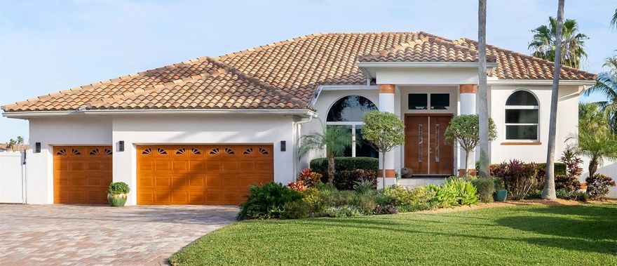 Nestled perfectly along the picturesque Grand Canal, this Tierra Verde home offers an exquisite blend of luxurious upgrades and scenic waterfront living. Custom walnut entry doors set the tone for the home's elegance and uniqueness. Floor-to-ceiling windows and doors abound, allowing natural light to flood the interior while providing breathtaking views of the Grand Canal. The gourmet kitchen is a chef's dream, equipped with bamboo cabinetry, a cooktop, resurfaced concrete countertops, and high-end appliances. Double ovens and a wine cooler add to the kitchen's functionality. A tiled breakfast nook offers a charming space to enjoy meals with a view. The master suite is a retreat with vaulted ceilings, custom closets, and fabulous water views. The master bathroom is a spa-like oasis with custom cabinetry, quartz countertops, a frameless walk-in shower, and a garden tub. All bedrooms feature hardwood flooring and custom closets, emphasizing quality and attention to detail. Guest bathrooms have been tastefully remodeled and showcase custom tile work. An incredibly spacious lanai provides the perfect setting for entertaining or simply enjoying the waterfront ambiance. The waterfront swimming pool and spa, complete with an additional sun deck, have updated heaters and equipment for year-round enjoyment. The refurbished dock features two lifts, offering convenient access to the water. The home boasts numerous updates, including a brand-new HVAC system, a brand-new generator, an updated water heater and updated ductwork. Updated lighting, exterior security lighting, and added fencing contribute to the home's security and aesthetic appeal. Custom pavers and tropical landscaping enhance the outdoor spaces, creating a resort-like atmosphere. Impact windows and hurricane shutters on the covered lanai provide peace of mind during inclement weather. A spacious 3-car garage offers ample parking and storage. Situated in the island community of Tierra Verde, the home is conveniently located near Gulf beaches, Fort DeSoto, restaurants, shopping, and Interstate 275. This Tierra Verde home is a testament to luxury, sophistication, and waterfront living at its finest, offering a perfect blend of comfort and style in an idyllic coastal setting.