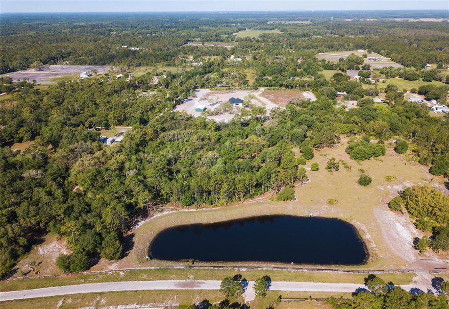 GATED  COMMUNITY vacant lot!  This beautiful partially cleared 13.2 acre lot is ready for your dream home.  This lot is two parcels with a pond and a creek running behind it.  This gives it seclusion all around.   Located in a new quiet neighborhood, approximately 200 acres, and close to town, beaches, airports, but far enough to feel secluded.  You can ride your horse around this community or ride less than 1 mile to an 8,000 acre preserve, known as Deep Creek Preserve.  This unique preserve limits access to non-motorized vehicles, horses, and foot traffic ONLY.  You don't have to have horses to appreciate this country community.  Enjoy the nearby Lake Ashby Park that is less than 1 mile from this lot, which has a boat ramp, fishing pier, playground, picnic area, and tent camping facilities.  Utilities are available in the area.  The lot will need a well and septic system. Survey required for exact lot dimensions. Builder Restrictions.; Cleared: Partial