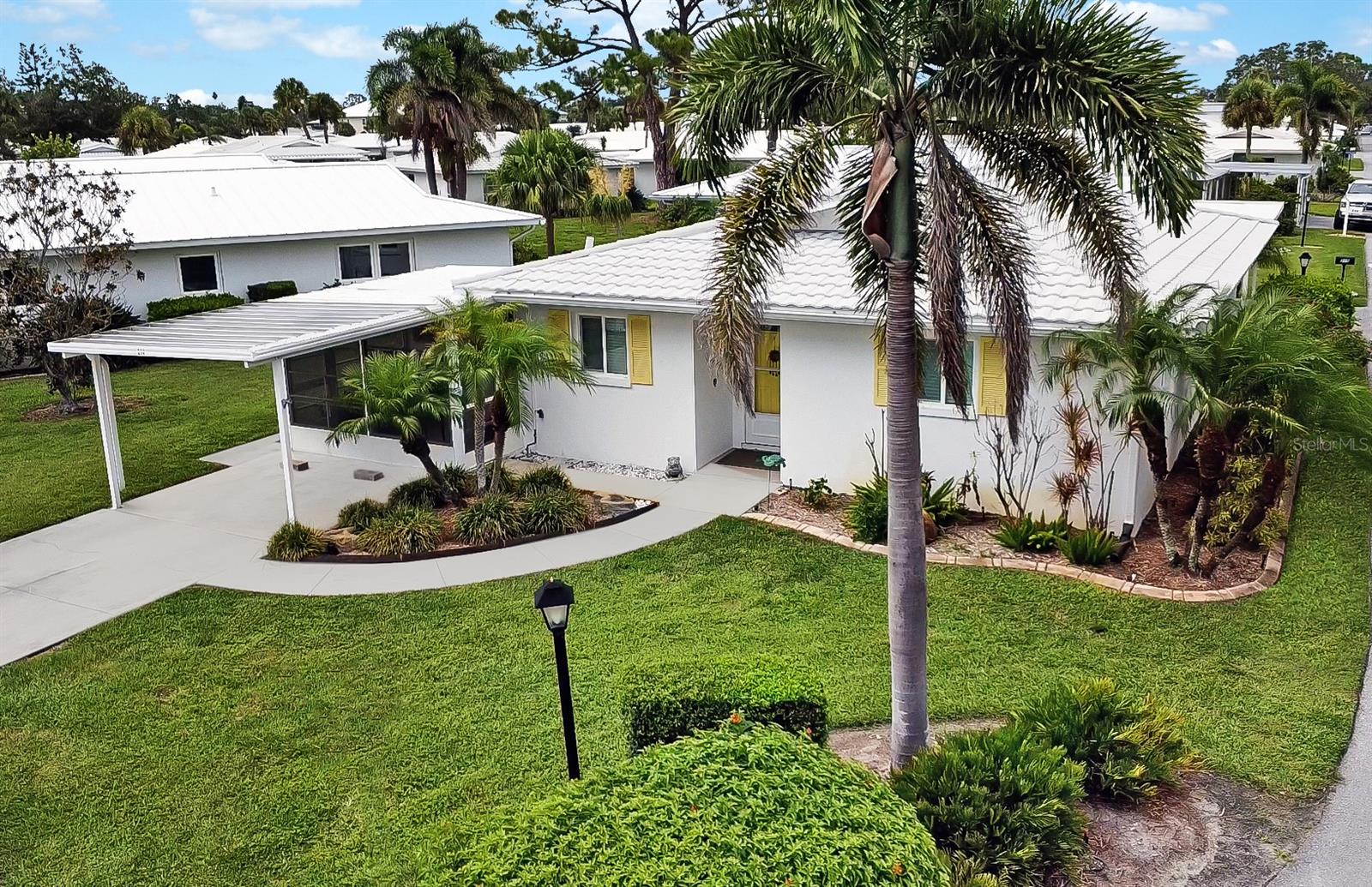 BRING YOUR BOAT! This rare and highly sought-after stand-alone villa—just ½ mile from the powdery sands of Nokomis Beach—comes with a DEEDED BOAT SLIP along the canal-side seawall, lift-ready and suitable for up to a 20-ft boat, complete with water and electricity at the slip, offering direct access to the Gulf for unforgettable sunset cruises, dolphin sightings, and weekend adventures. Located on a desirable corner lot in the vibrant, pet-friendly waterfront community of Fairwinds Village, this beautifully updated 2-bedroom, 2-bath home features a light-filled, open-concept layout with sleek 18"x18" ceramic tile throughout, Plastpro hurricane-impact windows, doors, and French doors that provide exceptional insulation—so well sealed, you won’t hear a sound from outside, wood blinds, and a stylish designer kitchen with quartzite countertops, brand-new stainless LG appliances, Bosch dishwasher, and under-cabinet lighting. Both bathrooms have been tastefully updated with modern vanities, and the home offers a variety of inviting indoor-outdoor living spaces, including a charming 3-season front porch with new epoxy flooring, an enclosed sunroom, and a private rear patio with freshly painted concrete and a remote-controlled retractable awning. Additional highlights include a durable metal barrel tile roof, privately owned irrigation system that runs off the community well, new HVAC system (2024), whole-house re-pipe (2023), and a tankless water heater (2020), ensuring comfort and peace of mind. Fairwinds Village residents enjoy resort-style amenities such as a heated pool, clubhouse, dog park, kayak launch and storage, pickleball, bocce ball, shuffleboard, and lush green spaces with tranquil canal views. Whether you’re walking, biking, or taking a golf cart to dinner, shopping, or grabbing a scoop at the local ice cream shop—or simply taking a peaceful stroll to the beach to catch a breathtaking Gulf Coast sunset—this home is more than just a place to live—it delivers the ultimate Florida lifestyle. Move right in and start living your coastal dream!