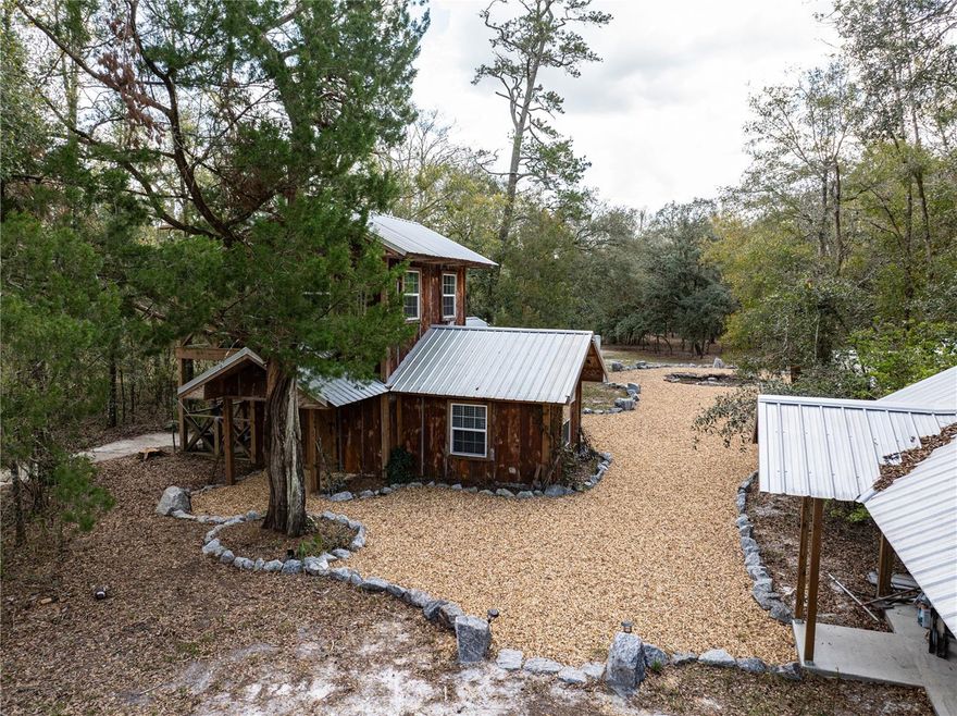 Discover 21+ acres of breathtaking, historical Old Florida land, featuring 875 feet of prime riverfront along the Santa Fe River. This extraordinary property is a rare find, offering natural beauty, privacy, and endless recreational opportunities. Located just a short drive or boat ride from the Ichetucknee River, Ginnie Springs, and Blue Springs, for some of Florida's best swimming, tubing, diving, and kayaking. Just around the bend, the Suwannee River flows out to the Gulf. The property has been selectively cleared, creating open grassy areas beneath Granddaddy Oaks. The Santa Fe River is known for its many springs, including one nestled in the cypress head just off this property's beachfront. Plenty of high and dry land - build your dream home, recreational retreat, vacation rental or other development opportunities. Improvements include a 2 story cabin with HVAC, covered porches, septic, well, solar electric, diesel generator, fire pit, carport. Schedule your private tour today!