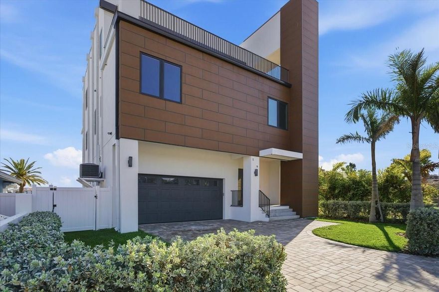 One or more photo(s) has been virtually staged. Welcome to your new luxurious estate located on highly desirable St. Pete Beach! Completed construction in late 2023, with new balconies installed in early 2025, this modern home boasts water views from every room. The ground floor consists of a multi car garage with the capacity to add a lift for additional car storage. As you walk towards the terrace, you will find a waterfront pool and full size outdoor kitchen suitable for all your entertaining needs. The second floor has an open floor plan design. Here you will find a large family room, full sized kitchen and breakfast bar. Adjacent to the family room, you will find a large dining room. The family room and dining space have panoramic views of the water. Located off of the open concept family space, is a spacious balcony where you can enjoy beautiful views of Boca Ciega Bay. The second floor includes two bedrooms each with its own en-suite bathrooms. The third floor has a large master suite with a spacious private balcony and a large master bathroom. This floor a bonus space that could either be a third bedroom, home office, or gym. Across the hall there is also a laundry/storage room. This waterfront estate has a centralized elevator that can help you or your guests travel throughout your home with ease. Come make this waterfront paradise your future home!