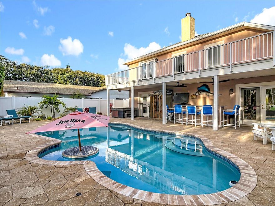 NO HOA & NEVER FLOODED! Experience coastal luxury like never before in this one-of-a-kind beachside retreat &nestled between the ocean & river. Custom-built in 2004, this 3-bedroom, 2 bonus room/lofts, 2 full-bath, & 2 half-bath home invites you to savor ocean breezes from two private balconies while admiring the beautiful sunsets of New Smyrna Beach.  Living room & master bedroom share a see-through fireplace that warms both rooms. Fireplace can be natural gas, wood burning or electric. Natural gas for utilities. With a Newer roof (2023), modern appliances, chic tile, & surround sound, every detail is refined! Just a few blocks from the no drive beach and the cities finest restaurants & bars. This home offers the best of both worlds—serene privacy and vibrant local life. Step into a large, exquisitely landscaped backyard that is a rare gem for beachside properties. Enjoy the brick paver walkway to the fire pit and private Trex dock with a kayak landing. Relax while catching fish, blue crabs or watching the rockets go off. Hop in your boat and go to one of your favorite restaurants on the water up and down the Intracoastal. Boat ramp is 5 houses down. Enjoy the saltwater pool with maintenance free paramount in floor cleaning system with a commercial grade natural gas heater for year round swimming. Generac 24kw whole house generator hooked up to natural gas so you will never be without electricity, which still has 7 years full warranty on maintenance and parts. This house has been through a many hurricanes and no damage. When I built I upgraded everything to hurricane standards and above. I have had the same maintenance man for 12 years and he knows every nook and cranny, so you can relax on how to work everything. This home is truly paradise in a quiet neighborhood. With the dual pane windows and doors you wont hear anything outside except the Rockets at Cape Canaveral. The backyard retreat is perfect for entertaining. Hot Tub & Sauna stay with the home. Great rental income during winter months. Home comes furnished with a couple exclusions. Ring doorbell camera. This hone has IT ALL!