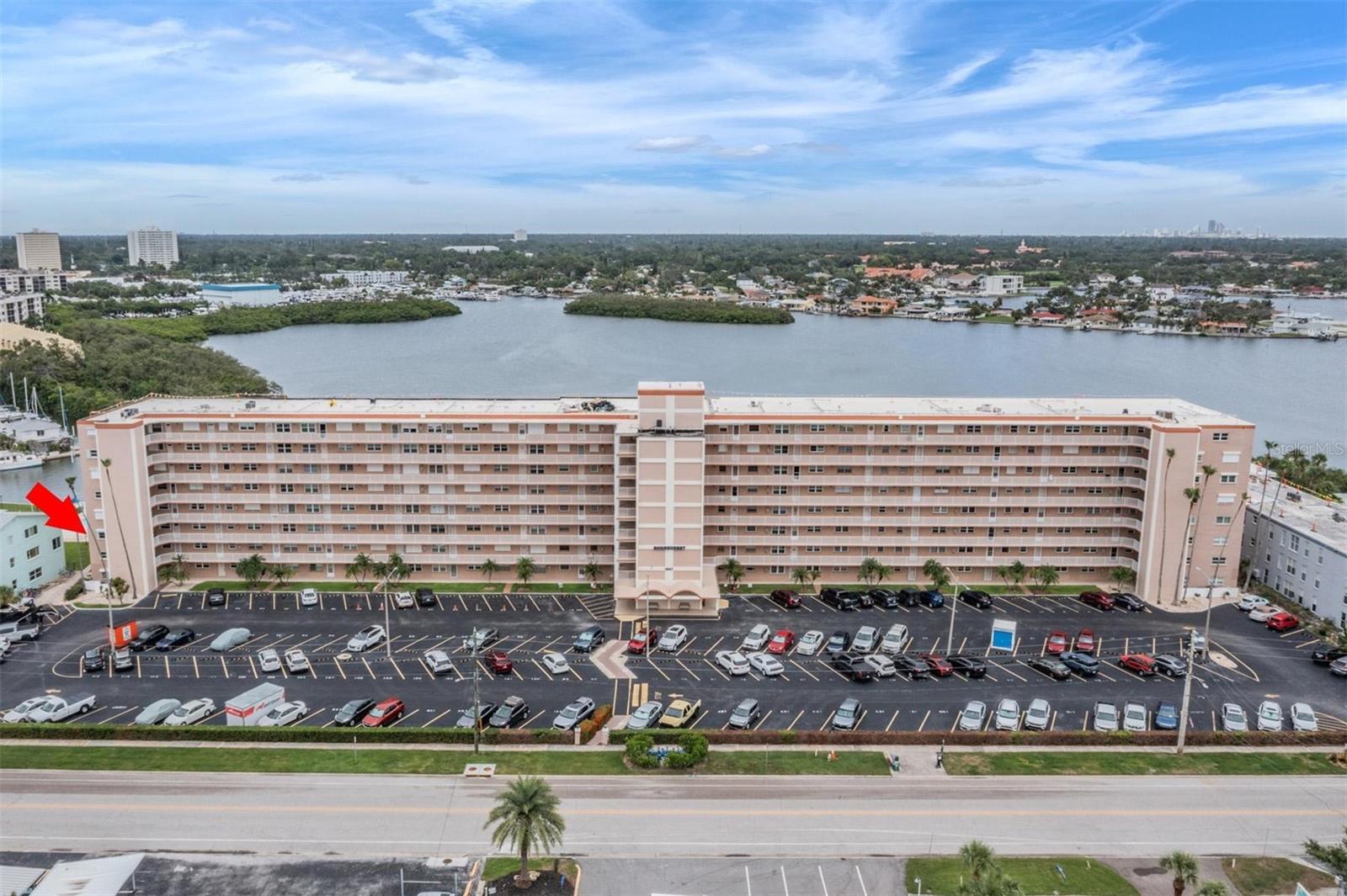 One or more photo(s) has been virtually staged. Experience the ultimate in Florida living with this beautifully renovated 2-bedroom, 2-bathroom end unit condo at Shore Crest. Perfectly situated with unobstructed views of the Boca Ciega Bay. Enjoy daily sightings of dolphins, manatees, seabirds, and an abundance of marine life right outside your window. This light-filled, tile floored residence features an open floor plan with neutral colors throughout, creating a bright and inviting atmosphere. The contemporary finishes make this home truly move-in ready. The kitchen is pristine with an abundance of solid hardwood cabinets with dovetailed drawers. No bending and reaching required as most of the lower cabinets have full pull-out drawers. A separate pantry provides added storage. The gas stove makes cooking a dream and the granite countertops gleam in the generous overhead lighting. The bar allows for easy conversation while cooking and is great for entertaining. The main bedroom is enormous with views of the bay. The on-suite bathroom features dual vanities (no sharing!) a custom walk-in shower with glass doors and a large closet. The entry door to the bath is oversized allowing for ease of aging in place. The second bedroom is on the other side of the unit, providing privacy. Each bedroom has a ceiling fan and two generously sized closets. The hall bath also has a walk-in shower with custom glass door. This spacious unit also features a rarely found in-unit laundry room with a full-sized washer and dryer. Directly outside of the unit is a separate storage room as an added bonus! The new windows throughout the unit are Miami-Dade rated against hurricanes and many include hurricane shutters. The building features a new roof (2025), newer plumbing and all the electrical in the unit has been replaced (2021). The condo fee includes Spectrum high speed internet and cable TV with a huge number of channels. Natural gas and water are also included in the condo dues. The dues also include a private dock for sitting and/or fishing, 2 heated swimming pools, library, shuffleboard, a clubhouse, and all the exterior and ground maintenance. There is an active kayaking group in the community and room to store your kayak on the outside kayak rack. Shore Crest is minutes from St. Pete Beach restaurants, hospitals, shopping and our top-rated beaches!