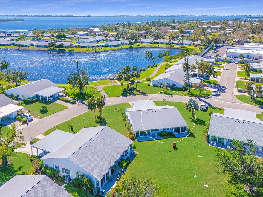 WELCOME TO YOUR COASTAL CANAL-FRONT VILLA- Nestled in the heart of a picturesque bay and canal front community this nicely appointed turnkey furnished residence is ready for your immediate enjoyment. With available boat docks and a prime location near the clubhouse and amenities just around the bend, this villa offers the ultimate Florida lifestyle. MODERN UPGRADES FOR PEACE OF MIND- You'll appreciate the thoughtfully updated features, including, 2022 impact windows, 2021 Trane HVAC system, and a 2019 Rheem water heater. SUPERIOR CONSTRUCTION & CONVENIENCE- Enjoy the security of a newer 2018 roof with third nails in the roof-wall connectors and solid concrete block construction. A private carport and driveway, along with a 12x5 secure storage unit for electric bikes, beach gear, and sports equipment, add to the villa’s convenience. Plus, guest parking is conveniently located on both sides of the villa. OUTDOOR BLISS- Step onto your spacious waterfront patio, a tranquil retreat for grilling, lounging, and watching mullet, manatees, and dolphins play in the canal. The expansive lawn offers ample space for bocce ball, croquet, and cornhole, while the carport seating area provides the perfect front-porch atmosphere to take in lake views and vibrant sunset skies. A BRIGHT & INVITING INTERIOR- Inside, abundant natural light and an open-concept layout create an airy and welcoming space, ideal for everyday living and entertaining. You’ll enjoy all the lovely views! 
A SPACIOUS KITCHEN- Designed for both convenience and function, the kitchen seamlessly connects to the dining area and features stainless appliances, a closet pantry, generous counter space, a handy breakfast bar, a deep double-bowl sink, and peeks at the sparkling lake and canal. The open layout ensures the chef stays connected to the festivities. SEAMLESS LIVING & DINING- The spacious dining and living area blend effortlessly, with a charming chandelier accenting the dining space and coastal-casual furnishings setting the perfect ambiance for relaxation and entertaining. Wall-to-wall windows provide captivating waterfront and nature views. Accessed from the living room the inviting lanai offers a serene retreat—perfect for starting your day with a morning coffee or unwinding in the evening as you enjoy the gentle breeze. SERENE BEDROOM RETREATS- The primary suite, tucked at the rear for privacy, boasts tranquil views, a spacious walk-in closet, and an ensuite bath with an updated vanity, lighting, fixtures, and a tub/shower combination. The secondary bedroom at the front features a wall of closets, serene lake views, and an adjacent bath with a stunning remodeled walk-in shower, updated vanity, cabinetry, lighting, and fixtures. EXTRA HIGHLIGHTS- This meticulously maintained villa also includes a storm door with a retractable screen, gutters and downspouts, ceiling fans, and a tasteful mix of tile and carpet flooring. COMMUNITY HAS IT ALL- clubhouse, banquet room, billiards, ping-pong, library/game room, lakeside veranda; boat docks; heated pool; tennis; pickleball; shuffleboard; bocce ball; spa; sauna; workshop; chip/putting green; walking paths; butterfly garden; bay front park; kayak launch/storage; bayside pavilion; lakeside gazebo; bird sanctuary; tidal pond; many lakes & spacious grounds of nearly 90 acres teaming with wonderful Florida wildlife; many activities/socials! ENJOY THE BEST- of coastal living with comfort & breathtaking surroundings. Schedule a showing today.