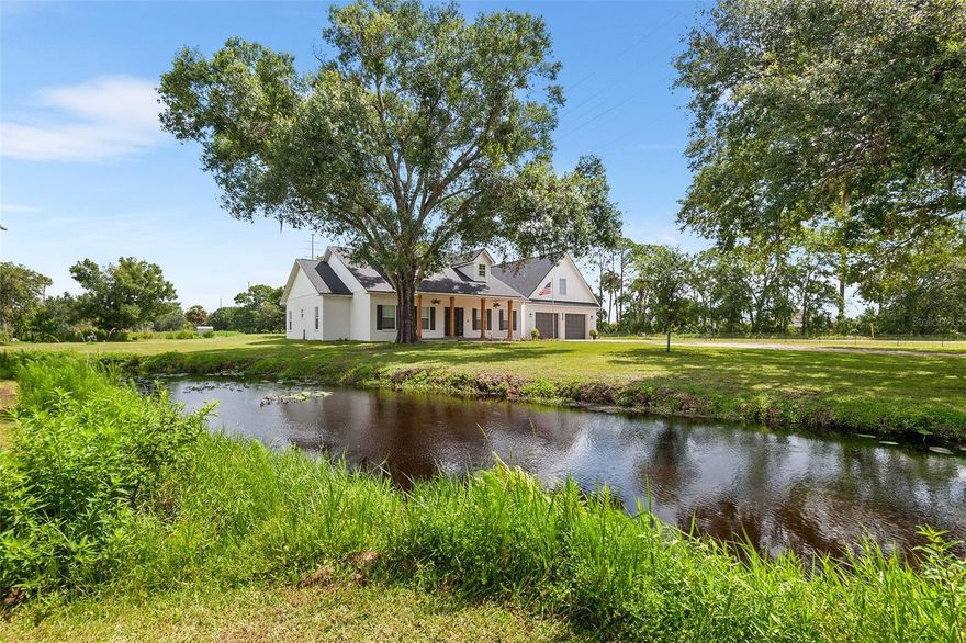 Looking for space to breathe, room to roam, and the freedom to live on your own terms? Welcome to 5820 E Johnson Ave in Haines City—a rare 17.71-acre farmstead in the heart of Central Florida that blends self-sustaining country living with modern comfort and convenient city access.

Set behind a private gated entry, the land is peaceful and picturesque, featuring a gently flowing creek, multiple access points, cross-fenced pastures for horse or livestock rotation, a large chicken coop, and a hog pen—all ready for those dreaming of raising animals, growing their own food, or simply enjoying the serenity of wide-open land.

At the heart of the property is a beautifully renovated modern farmhouse offering over 3,000 square feet of comfortable living area and more than 4,000 square feet under roof. Inside, you’ll find high ceilings, soft-hued plank flooring, energy-efficient double-pane windows, and a cozy wood-burning fireplace that adds warmth and charm.

The showpiece kitchen is designed for farm-to-table living, featuring quartz countertops, stainless steel appliances, ample cabinetry, and a wrap-around breakfast nook perfect for gathering with family and friends. The split-bedroom layout ensures privacy, with the spacious primary suite offering access to the screened back porch, a large walk-in closet, and a well-appointed en-suite bath. Two additional bedrooms and a full bath are tucked away on the opposite side of the home.

Additional living spaces include a formal dining room, a versatile room that can serve as an office or fourth bedroom, and a large screened-in porch overlooking the peaceful acreage beyond.

Upstairs features a spacious bonus room—ideal for a playroom, home theater, man cave, or more—alongside a separate air-conditioned storage room. Whether you choose to convert this area into another bedroom or use it to safely store décor, valuables, or important documents, the possibilities are both practical and flexible.

An oversized three-car garage and multiple storage sheds provide ample space for equipment, hobbies, or expanding your agricultural vision. And while the property feels like a peaceful world of its own, you're just 3 minutes from Publix, 15 minutes from Lowe’s, 30 minutes from Posner Park, and 45 minutes from Orlando’s shopping, dining, and entertainment.

Located in the vibrant and fast-growing community of Haines City, this property enjoys the best of both worlds—rural tranquility with easy access to top-tier amenities. Known as the “Heart of Florida,” Haines City offers charming local restaurants, beautiful parks, and proximity to some of the region’s most popular destinations. You’re just 30 minutes from Walt Disney World, surrounded by world-class golf courses including Southern Dunes and ChampionsGate, and less than an hour from Orlando International Airport, making travel and recreation incredibly convenient.

Whether you're envisioning a working ranch, a private retreat, or simply a place where you can live life on your own terms, this exceptional property delivers.