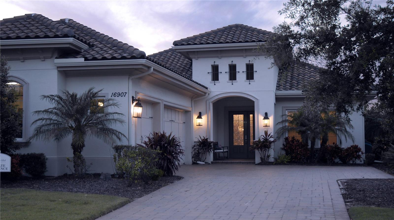 This Stunning Birchwood Model Home in the exclusive gated Genoa neighborhood of The Lake Club in Lakewood Ranch is now available for lease. Built by Stock Signature Luxury Homes, the home features professional decor by Clive Daniel Home and numerous custom upgrades.
Key highlights include:
An expansive foyer leads to a formal family room with custom tray ceilings.
A gourmet kitchen with modern cabinetry, an oversized Quartz island, built-in speakers, and high-end stainless steel appliances, including a natural gas Wolf cooktop.
A versatile study suitable for work or meditation.
A spacious master suite with his and her walk-in closets, an oversized bathroom, and automated window blinds.
A custom-built lanai with a summer kitchen, built-in speakers, a pool/spa package, and a pool bath overlooking the lake.
An air-conditioned garage with custom storage and a Garage Gator lift.
The Lake Club offers a Tuscan-inspired landscape, scenic lakes, and a 20,000 sq. ft. Grande Clubhouse with luxurious amenities, including a fitness center, spa, multiple sports facilities, and concierge services. This model home provides an exceptional opportunity for luxury living, close to beaches, parks, shopping, and dining in downtown Sarasota.