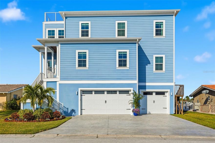 One or more photo(s) has been virtually staged. Welcome to your dream waterfront oasis! This stunning 3-bedroom, 2.5-bathroom home with a spacious 3-car garage is perfectly situated on a saltwater canal with direct access to the beautiful Gulf waters of Florida—ideal for boating and coastal living enthusiasts. From the moment you arrive, the charming decorative concrete driveway and mature Florida-style landscaping set the tone for what awaits inside. Step through the front door and be captivated by soaring ceilings and an abundance of natural light that enhances the home’s bright, open feel. The beautifully designed kitchen offers stainless steel appliances, granite countertops, a stylish backsplash, and a center island bar perfect for casual dining and entertaining. A large pantry ensures plenty of storage space. Just off the main living area, a convenient half bath is ideal for guests. The open-concept layout flows seamlessly into the spacious dining and living areas, creating the perfect gathering space. Upstairs, you’ll discover a cozy bonus area—ideal for a home office, den, or additional entertainment space. The spacious primary suite features private balcony access where you can unwind while enjoying serene water views. The ensuite bathroom includes a dual-sink vanity with ample storage and a luxurious custom-tiled walk-in shower, along with dual walk-in closets. The secondary bedrooms share a beautifully appointed bathroom with a dual vanity and a tub/shower combination. The oversized laundry room includes a utility sink for extra convenience. A rare highlight of this home is the rooftop deck, offering breathtaking views and the perfect spot to sip your morning coffee or watch the sunset over the water—an exclusive feature not commonly found in the neighborhood. Step outside through the French doors on the main level and enjoy an expansive covered porch overlooking the peaceful canal. The large private dock features two boat lifts (10k and 13k pounds) offering quick and easy access to open water and endless days on the Gulf.  Bonus! This elevated home is also pre-framed for a future elevator!  Conveniently located near shopping, dining, entertainment, and medical facilities, and just minutes from the vibrant Downtown New Port Richey area—home to Sims Park, local boutiques, entertainment, and popular waterfront eateries. Don’t miss your chance to experience Florida waterfront living at its finest -schedule your private showing today!