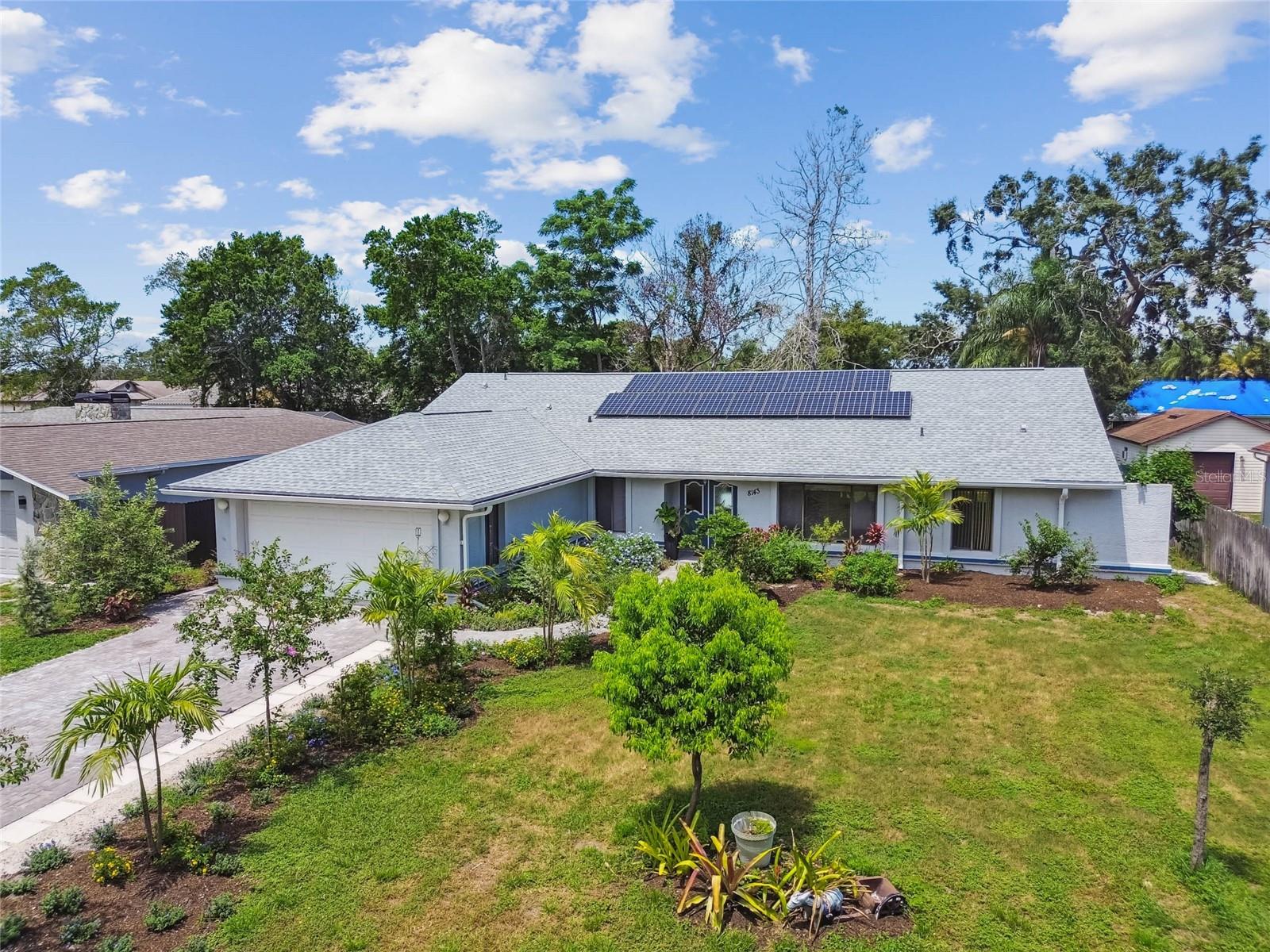 Welcome to this 3-bedroom, 2-bath home featuring a NEW ROOF (2023), freshly manicured landscaping, and a striking PAVERED driveway and walkway that set the tone with exceptional curb appeal. Vaulted ceilings with a center beam enhance the spacious great room, which flows seamlessly into the kitchen, formal dining, and living areas. The split-bedroom layout offers privacy, while direct access to the large screened lanai is available from the primary suite, dining room, great room, and guest bedroom. The primary suite includes a unique en-suite bath with a spa-like shower featuring a full-length glass window that creates the serene feeling of showering outdoors in complete privacy. Additional highlights include owned solar panels for energy efficiency, a sprinkler system on its own well providing $0 irrigation costs, an osmosis water system, UV light water treatment system, and a water softener. With vision, creativity, and some fresh paint and flooring, this home can be transformed into a remarkable retreat. Located in the established Forest Oaks neighborhood of Spring Hill, this home offers a quiet residential setting with easy access to US-19, SR-50, and the Suncoast Parkway for a convenient commute to Tampa. Nearby are shopping, dining, healthcare facilities, and schools including Deltona Elementary, Fox Chapel Middle, and Central High. Schedule your private showing today!