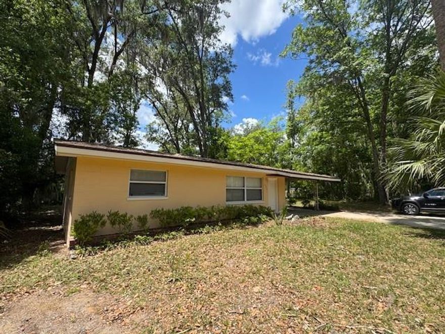 Cute house in central location popular Ocala Highlands.  2 Bedroom 1 bath house of 952 sf of living space in SE with brand new Carpet in living room and Bedrooms and new roof in 2024.  Newer windows and fenced yard. Covered single Carport wtih utility room on the end for washer and dryer has the water heater and HVAC in it.  Inviting house faces east and has paved road frontage on SE 30th Avenue.  House has two bedrooms with double closet in one.   Hall closet has larger linen closet and built in hamper with shelf closet above.   Bathroom is remodeled wtih large shower with glass door and tiled surround.   Kitchen has original wood cabinets and good counter space and looks out to back yard.  Eat-in kitchen area with door to back yard.  Best part of this property is it is on two lots.   House is on .20 acre 75 x 115 and adjacent lot included to the north is wooded with 150 feet frontage and 62 feet depth. (.21 Acre) 2 Parcel numbers.    Will need a variance with City to Build a house, or use for wooded play yard to side for extra space.  This gem is a great find with Ward Highlands School and Forest High School .   so close to Jervey Gant Park, and the Ocala community swimming pool on SE 36th Avenue.