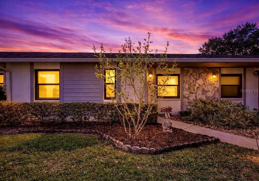 Welcome to this beautifully updated one-story villa in the centrally located community of Harshaw Lake Park Condominiums, offering comfort, style, and easy Florida living in one of St. Petersburg’s highest elevations—safely in a non-flood zone.

Step inside to a thoughtfully reimagined 1,225 sq ft layout where every detail has been carefully chosen. The heart of the home is the stunning, newly designed kitchen, finished in warm neutral tones with granite countertops and backsplash, a sleek cooktop, and a built-in elevated oven. A large stainless-steel sink with touchless faucet adds modern convenience, while a generous built-in pantry keeps everything effortlessly organized. The adjacent eat-in space is currently used as a home office, but easily adapts to a cozy breakfast nook, creative studio, or hobby area.

Luxury vinyl flooring flows throughout the living areas and bedrooms, complementing the clean, cohesive feel of the home. Both bathrooms have been tastefully updated, including the primary suite featuring a rare double-sink vanity—an upgrade not found in most original units.

Natural light pours into the enclosed rear porch, creating a bright and airy sunroom that expands the living space and invites you to relax year-round. Just beyond, a full-width patio opens to a lush, green backdrop—with no rear neighbors, offering a peaceful sense of privacy.

Practical upgrades add real value, including hurricane-impact windows throughout and a new 2025 heat pump A/C system. The villa design also allows for abundant attic storage with easy pull-down access—something you simply don’t get in most condo living. An interior laundry room with full-size washer and dryer adds everyday convenience.

Covered parking is included with a private carport, and the community itself is designed for connection and enjoyment, featuring a centrally located pool, clubhouse with kitchen, gathering space for events and activities, and even a quiet library.

Pet-friendly and allowing leasing, this 55+ community in the Disston Heights neighborhood offers ready occupancy for snowbirds and full-time residents alike, along with a relaxed lifestyle. Ideally located just minutes from downtown St. Petersburg and in close proximity of Historic Kenwood/Grand Central District. The Gulf beaches are just a short drive away, and it is within easy reach of shopping, dining, and daily conveniences.