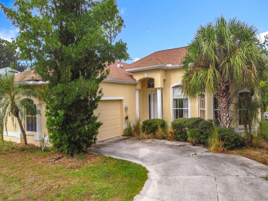 No HOA or CDD Fees. Experience how soaring 10, 11, and 12-foot ceilings transform the feeling of space throughout your home. Built by an industry insider, this isn’t just another standard Florida design with cathedral peaks and 8-foot ceilings in the bedrooms. It's balanced architecture with 10', 11' and 12' (+/-) tall ceilings in every room from beginning to end. Every element was designed with purpose: Primary bedroom includes a large en-suite, a large walk-in closet, pocket-sliders to the Lanai, where a simple trim of the backyard vegetation will give you a view of the freshwater canal,  a family room featuring lighting built into the double-tray ceiling, wide-open L-shaped pocket sliders that blend the living areas with the Lanai for seamless indoor–outdoor comfort, whole-house crown molding throughout,  and an oversized 529 sq. ft. garage with a large front window and a side yard utility door. The garage has plenty of space for storage and a workspace area.   A spacious walk-in closet with those tall ceilings giving flexibility for storage or design creativity. According to the latest data, very few North Port homes feature ceilings of this height. This is a structurally solid home. A few minor cosmetic improvements can quickly elevate its value and appeal. A must see for any serious buyer! Schedule your private showing today or reach out for more details.