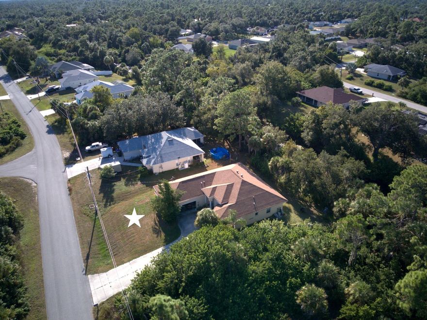 Experience how soaring 10, 11, and 12-foot ceilings transform the feeling of space throughout your home. Built by an industry insider, this isn’t just another standard Florida design with cathedral peaks and 8 foot ceilings in the bedrooms. It's balanced architecture with 10', 11' and 12' (+/-) tall ceilings in every room from beginning to end. Every element was designed with purpose: a family room featuring lighting built into the double-tray ceiling, wide-open L-shaped pocket sliders that blend the living areas with the Lanai for seamless indoor–outdoor comfort, whole-house crown molding throughout,  and an oversized 529 sq. ft. garage that delivers the storage and workspace every homeowner would love to have. Pocket-sliders in the primary bedroom open to the Lanai, where a simple trim of the backyard area vegetation will give you a view of the freshwater canal.  A spacious walk-in closet with those tall ceilings giving flexibility for storage or design creativity. According to the latest data, very few North Port homes feature ceilings of this volume. This is a structurally solid home with room for cosmetic improvements. It's the kind of property where your personal cosmetic whole-house facelift can quickly elevate its value and appeal. A must see for any serious buyer. Schedule your private showing today or reach out for more details.  (Home preparation underway for interior photos, featuring a spacious primary suite with a private ensuite!)
