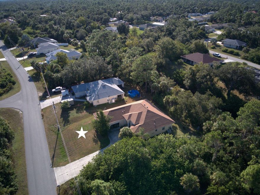 Experience how soaring 10, 11, and 12-foot ceilings transform the feeling of space throughout your home. Built by an industry insider, this isn’t just another standard Florida design with cathedral peaks and 8 foot ceilings in the bedrooms. It's balanced architecture with 10', 11' and 12' (+/-) tall ceilings in every room from beginning to end. Every element was designed with purpose: a family room featuring lighting built into the double-tray ceiling, wide-open L-shaped pocket sliders that blend the living areas with the Lanai for seamless indoor–outdoor comfort, whole-house crown molding throughout,  and an oversized 529 sq. ft. garage that delivers the storage and workspace every homeowner would love to have. Pocket-sliders in the primary bedroom open to the Lanai, where a simple trim of the backyard area vegetation will give you a view of the freshwater canal.  A spacious walk-in closet with those tall ceilings giving flexibility for storage or design creativity. According to the latest data, very few North Port homes feature ceilings of this volume. This is a structurally solid home with room for cosmetic improvements. It's the kind of property where your personal cosmetic whole-house facelift can quickly elevate its value and appeal. A must see for any serious buyer. Schedule your private showing today or reach out for more details.  (Home preparation underway for interior photos, featuring a spacious primary suite with a private ensuite!)