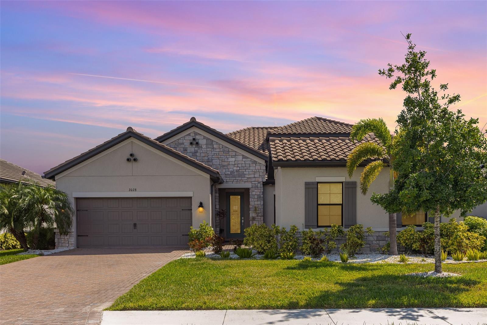 Imagine the truest form of a luxury lifestyle paired with the finest Florida living! Welcome to 2028 Woodleaf Hammock Court of the wonderful Lakewood Ranch community in Bradenton. At almost 3,000 square feet of space, this haven isn’t just a house but a canvas to make new memories. With 4 full bedrooms, 2 extra bonus rooms and 5 full bathrooms, there’s enough space for every dream, every guest or every hobby that your family can have! From the entry courtyard, the right hand door is the private entrance to our mother-in-law suite with a kitchenette and beautiful full bathroom. To our left, we enter the dream home where we find vaulted tray ceilings, seamless luxury flooring, an abundance of natural light, a built-in sound system and many more details From the huge gourmet chef’s kitchen, to the elegant open floor plan, with the heated saltwater pool wrapped in travertine tiling and even the full outdoor kitchen. Equipped with 2 HVAC units, complete exterior gutters, a gorgeous paver driveway, upgraded white quartz rocks landscaping, a sturdy tile roof, a custom indoor storage room and a large attached 2-car garage. Designed & built in 2021 with comfort, peace of mind, functionality and entertainment all wrapped into one and future owners can receive the 15 year transferable builder warranty! Qualifying buyers can also potentially assume the owners mortgage at a 2.6% interest rate! Along with the home, the Woodleaf at Lakewood Ranch community offers lots of amenities from a resort style pool, to grilling areas, dog parks, pickleball courts and a kid’s playground. Nearby you have A-rated schools, lots of restaurants, plenty of shops, several parks, golf courses & clubs and quick access to so much more with I-75 being minutes away. This isn’t just a listing, but an invitation to a life beautifully lived, so schedule your private showing today!
