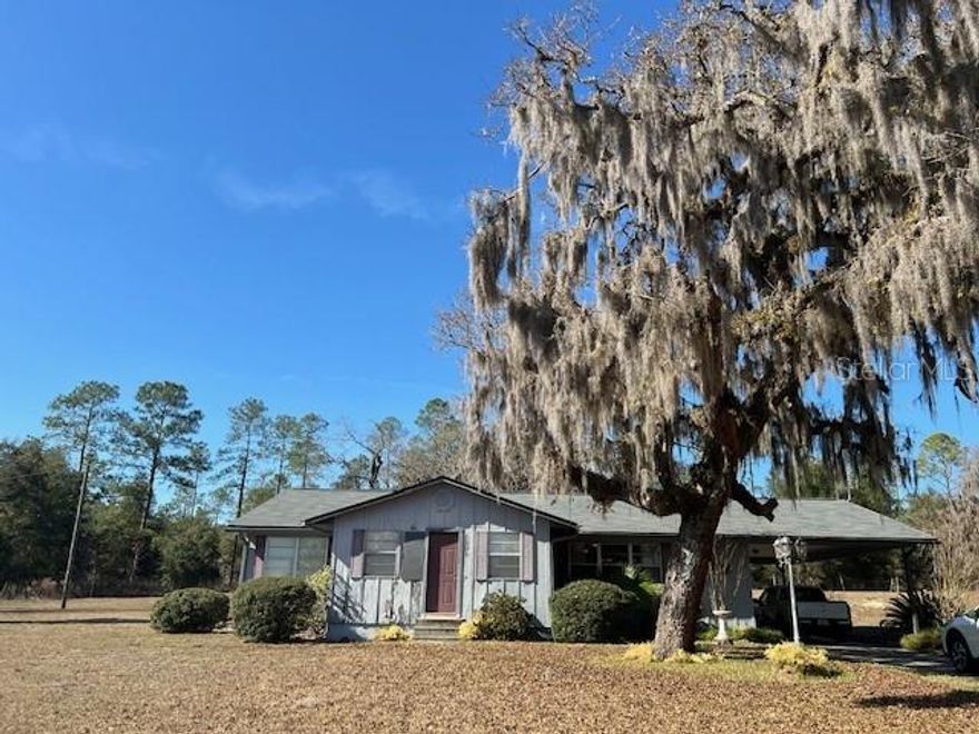 **BACK ON THE MARKET**  The view goes on forever from this house on the hill. Gorgeous vista from the front porch. Sprawling, cleared 13+ acres on CR337 between Trenton and High Springs with comfortable home. Beautiful stone fireplace in living room. Bedrooms are spacious. Enclosed front porch is great bonus space. Basements are rare in Florida, but this house has a full size unfinished basement! Entire property is fenced. Roof is 2 years old, AC is one year old, well pump 2 years old, drain field 2 years old. Close to fresh water springs, rivers and a wide range of recreation opportunities. Bring your horses and make a farm!