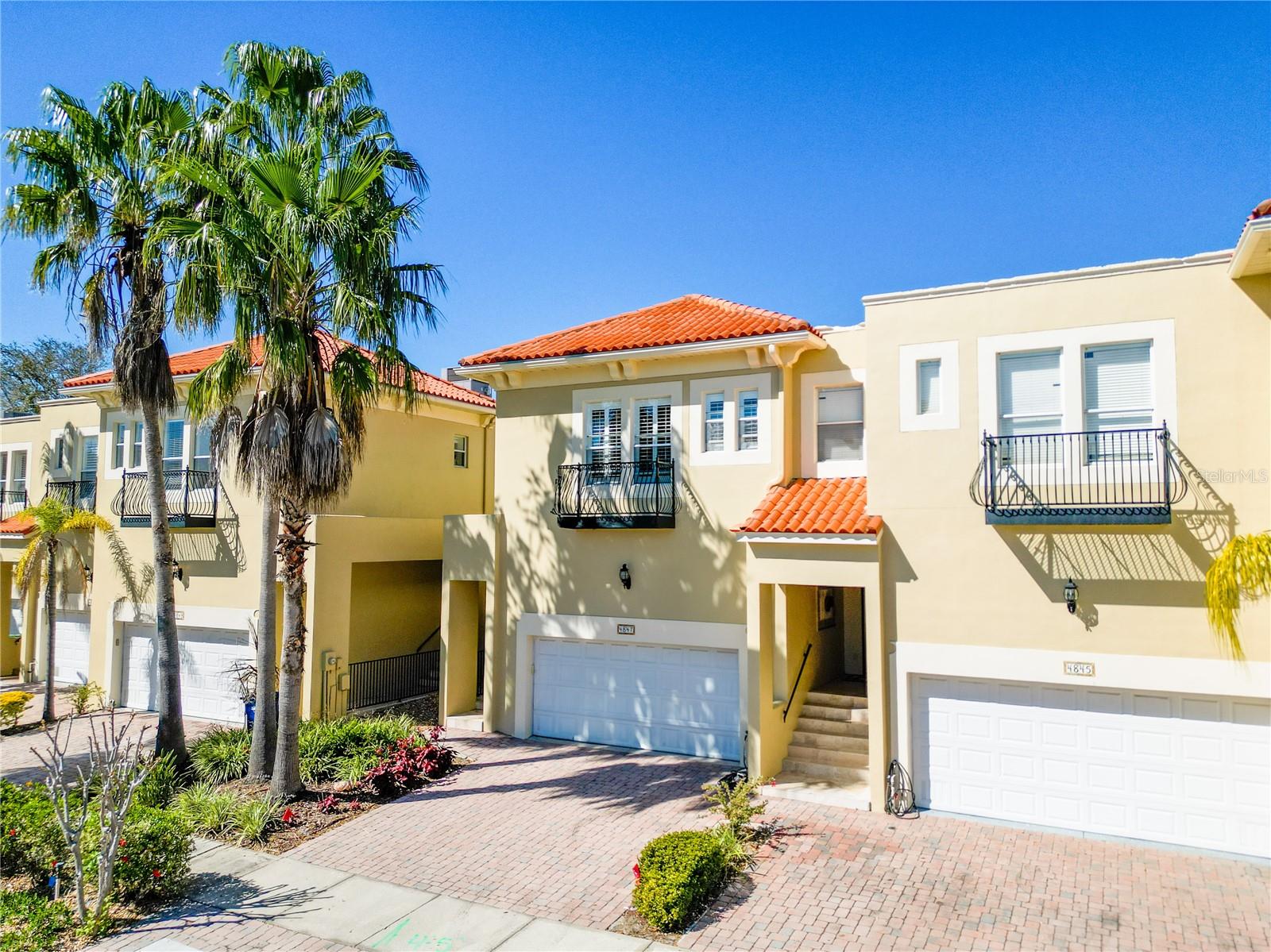 Experience custom luxury Mediterranean living in this South Tampa townhome. Nestled on a quiet, dead-end street amidst the beauty of oak trees and tropical landscaping, this one-of-a-kind residence stands apart from the rest. Every detail of this property has been carefully curated by, creating a truly remarkable and unique home. A paved driveway leads you to an oversized two-car garage with ample storage space. As you step inside, the elegance of travertine flooring greets you, flowing seamlessly throughout the spacious downstairs living area. The new-renovated kitchen is a chef's dream, boasting custom cabinets, stone countertops, and stainless steel appliances. Crown molding adorns every room, while plantation shutters and additional recessed lighting add a touch of sophistication.
Continuing upstairs, a custom staircase with Santos Mahogany flooring leads you to the second level. The primary bedroom features custom closet built-ins, and 8-ft solid core interior wood doors provide privacy and elegance throughout. French doors beckon you outside to a tropical paradise, with a large deck on the lower level for seamless indoor-outdoor entertaining, and an oversized patio on the second story offering a private retreat. Minutes to Downtown Tampa’s Riverwalk, Amalie Arena, MacDill Air Force Base, Tampa International Airport, I-275, I-4, A-rated Robinson High School, shopping, restaurants, parks, and more!