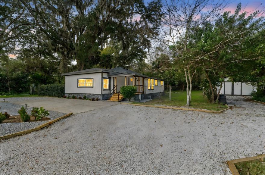 Come see this completely remodeled 3 bedroom, 2 bathroom home on a rare half-acre corner lot in the heart of New Smyrna Beach. This property has been beautifully updated inside and out and features a Brand New Roof (2025), New Energy-Efficient Windows (2025), and a New Tankless Hot Water Heater (2025). Inside, you’ll find stunning luxury vinyl flooring throughout, accented by brand-new floorboards and fresh interior paint that creates a clean, modern feel. The fully updated kitchen offers soft-close cabinetry, gorgeous quartz countertops, a custom built-in eating bar, and all new stainless steel appliances- including refrigerator, dishwasher, gas stove, and microwave. Additional interior upgrades include smart light switches, new ceiling lighting and fans, an updated laundry room, and thoughtful touches like an entry window seat with storage. Situated on a spacious half-acre, the property provides ample room for boat or RV storage and is exemplified by a cozy firepit area with a picnic table. The exterior has been fully refreshed with new paint, updated front and rear porches, new exterior lighting, newly installed landscaping in both the front and back yards, and even a brand new mailbox. The versatile shed in the backyard offers endless possibilities- use it as a gardening shed, extra storage space, or even convert it into a charming chicken coop The garage offers generous space for parking, projects, or additional storage and includes a new epoxy-coated floor and elastomeric roof coating. Security features including Blink cameras and a Ring doorbell are also included for added peace of mind. This move-in-ready home delivers exceptional space, privacy, and modern updates throughout.