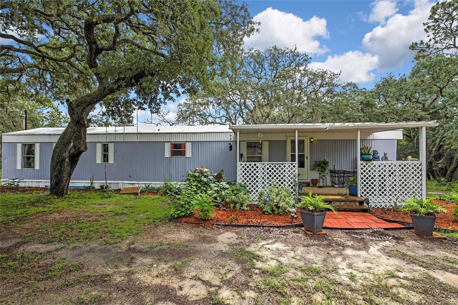 Looking for a quiet home with No HOA fees or Deed Restrictions and backed-up to the National Forest- this home is for you! This beautifully maintained and recently updated, Furnished, 2 Master Suite Split-Plan home is located on a dead end road, and on .39 acres. Backing this home is the unincorporated land owned by the Forestry of Withlacoochee State Forest. This home also has a bonus 10x20 room that can be used as an office, workshop, or bonus space with a seperate entrance and second covered porch. The 10x10 metal shed in the back is available for storage and houses the laundry. This home is minutes away from the Gulf, Boating, Fishing, Kayaking/Canoeing, Biking, Hiking, and so much more. UPDATES: Hurricane Straps 2022, New Duct Work 2022, Septic and New Leach Field 2022, Replaced Main Power Meter to the house, Kitchen updated 2024, New restroom Vanities, all New Flooring, Freshly Painted Interior & Exterior. Sanded and Stained Porches. New Water Heater 2025, New Pressure Tank 2025. This home is being sold FURNISHED...so come move right-in and enjoy your time relaxing!