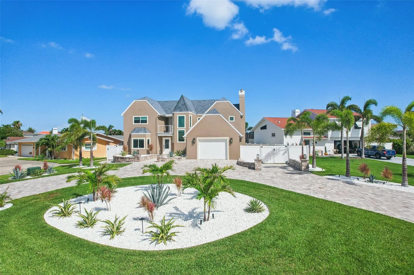 Step into a world of coastal luxury in this impeccably renovated home, ideally situated on nearly a quarter acre in the prestigious Bellevue Estates Island of Belleair Beach—one of the area’s highest points, allowing this home to experience no flooding in the historic storms of 2024. From the moment you arrive, the brand-new pavered circular drive, fresh landscaping, and elevated planters hint at the exceptional living experience within. Spanning nearly 2,800 square feet, this 4-bedroom, 2.5-bath home has been thoughtfully reimagined with top-tier finishes and effortless elegance. Inside, the gourmet kitchen is a culinary masterpiece—equipped with premium appliances, a sprawling center island, solid stone countertops, and an inviting breakfast nook that captures views of the lush backyard and tranquil cove. Host unforgettable gatherings in the formal dining room, where picture windows frame the water’s edge. The expansive great room invites relaxation and connection, anchored by a stately fireplace and oversized sliders that open to a serene rear deck—perfect for sunset cocktails or morning coffee. A second, private front balcony provides another picturesque perch to take in glimpses of the Intracoastal Waterway. Upstairs, you’ll find oversized bedrooms, including the owner’s suite, which offers stunning water views and breathtaking sunsets from its spacious 200-square-foot private deck. This spa-like retreat features a large walk-in closet and a beautifully appointed ensuite bathroom with dual vanities, elegant tilework, and a glass-enclosed shower—all bathed in natural light from an overhead skylight. The remaining upstairs bedrooms are all generously sized and share a beautifully updated full guest bathroom, offering comfort and convenience for family and guests alike. Every detail has been curated to elevate daily living—from the Cat 5 impact-rated windows and sliders to the peace of mind provided by newer systems: main electrical panel (2020), roof (2019), and dual AC units (2013 & 2020). Step outside to your personal backyard sanctuary, where a sparkling pool with a tanning shelf and advanced heating/cooling system invites year-round enjoyment. Boating enthusiasts will appreciate the private dock with a 10,000 LB boat lift—offering quick access to the Intracoastal and just minutes to the sparkling expanse of the Gulf. Fish from your own backyard and watch manatees and dolphins swim by. Located in a quiet, non-commercialized neighborhood, Belleair Beach offers private resident-only beach access and parking, tennis and basketball courts, a marina, and a recreation center—all just moments from world-renowned beaches, shopping, and dining. This is more than a home—it’s a rare opportunity to own a piece of Florida’s most exclusive coastal lifestyle. Schedule your private showing today.