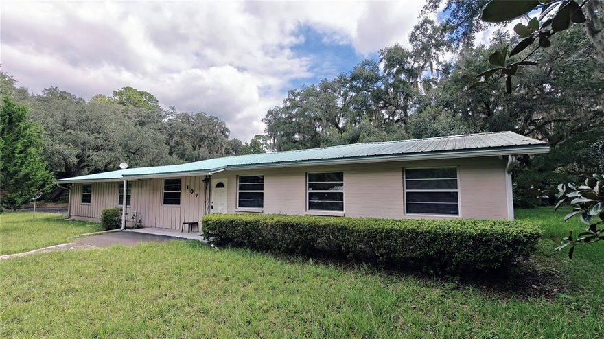 Back on the market at no fault of the seller. Rare Micanopy find, one-of-a-kind 3/2 ranch nestled on a generous 1.29-acre lot in charming Micanopy, Florida. A short drive to UF Shands Hospital, UF campus, The Swamp, midtown and Archer Road dining and shopping. This home features newly refinished terrazzo floors in living-room, hallway and shared bathroom, new carpeting in bedrooms, dining and family rooms, fresh interior paint throughout, a new water heater, a lasting 2008 metal roof and a water purification system. The oversized two-car garage has an air-conditioned workshop and side access to the backyard and adjacent block building (with electrical), which could convert to an in-law suite or income generating Airbnb. Star gaze in your own backyard among stunning oaks, visit the Tuscawilla trails and Native American Preserves down the street, or check-out the downtown Micanopy lifestyle!