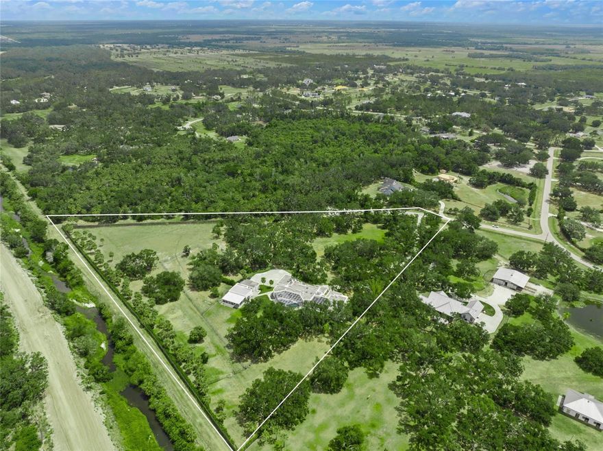 ONE OF A KIND MODERN MASTERPIECE! A MUST SEE! * SPECATCULARLY REMODELED, BEAUTIFULLY UPDATED FAMILY ESTATE IN HIGHLY SOUGHT AFTER SADDLE CREEK * Perfectly positioned among the majestic oak trees & custom landscaping on a RARELY AVAILABLE 12.18 ACRES with STUNNING PANORAMIC VISTAS! * ALSO AVAILABLE: MLS# A4651030, THE ADJACENT 6.41 ACRES, LOT #53 CREATING AN 18.59 ACRE PARADISE * THIS TIMELESS ARCHITECTURAL DESIGN WILL CAPTURE YOUR HEART * From the moment you enter the PRIVATE GATE and drive down the winding driveway you will appreciate the PRIVACY & THE SERENITY * Located on a quite cul de sac with no drive through traffic * Open the glass front doors to VOLUME CEILINGS showcasing an ABUNDANCE OF NATURAL LIGHT * 8 Foot Glass Doors and Transom Windows * NEW IMPACT WINDOWS & DOORS ARE MISSILE RATED UP TO 160MPH * The Chef's open GOURMET KITCHEN has been LOVINGLY REMODELED with NEW cabinets and Miele appliances * The current homeowner painstakingly oversaw every step of the remodel from the kitchen to the bathrooms to the NEW TILE FLOORING * NEW LIGHTING * NEW PAINT INSIDE & OUT * WHOLE HOUSE KOHLER GENERATOR * The SPACIOUS Primary Suite is a true retreat with a large sitting area, fireplace & a Spa-style Bath with a walk-in shower, separate tub, and an upper level Library or Office designed as a quiet escape * 5 Bedrooms * 4 Full Baths * 2 Half Baths * THE DETACHED 1880+/-sqft BUILDING IS A PERFECT ART STUDIO, FITNESS CENTER, GAME ROOM OR GUEST QUARTERS * THIS IS THE PERFECT HOME FOR MULTI-GENERATIONAL LIVING OR EXTENDED STAY FAMILY OR GUESTS * LARGE Driveway and Parking Pad with ATTACHED 3 Car Garage is 38x25 * PLUS A DETACHED GARAGE + DEEP CARPORT * Property is Gated + Fenced + Cross Fenced * COULD BE AN EQUESTRIAN DREAM HOME! * At the rear and side of the estate, you can enjoy direct access to 25+ miles of Saddle Creek equestrian + bridle riding trails * Bring the whole family, the animals - big & small, all the toys - big & small * MAKE THIS YOUR FAMILY ESTATE * Enjoy your slice of paradise * Beautiful, PRIVATE setting * EXCELLENT 'A' RATED SCHOOL DISTRICT * 5 miles to I-75 and just 13 miles to Siesta Key Beach * 5 minutes to Publix and other shopping * Country feel yet close to town * One look & you'll fall in love! *