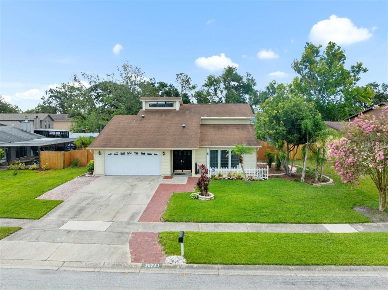 Welcome to this well-maintained home offering timeless design and everyday comfort. Featuring 3 spacious bedrooms, 2.5 bathrooms, and over 2,100 sq ft of versatile living space, this home is nestled in a peaceful neighborhood and blends indoor elegance with outdoor relaxation. Step inside through double-entry doors to a welcoming foyer and bright formal living and dining rooms—perfect for gatherings and holidays. The spacious family room, with custom built-ins and sliding glass doors, flows seamlessly to the backyard and sparkling pool. The kitchen offers plenty of cabinet and counter space, plus a cozy dinette overlooking the pool—ideal for everyday meals. The primary suite is a true retreat with multiple closets, a large vanity, walk-in shower, and garden tub. Two additional bedrooms are generously sized with ample natural light and closet space. Out back, enjoy your private oasis with an open pool, fenced yard, and space for barbecues or play. The garage provides secure parking, laundry area, and extra storage. Located close to top schools, parks, dining, and commuter routes—this home combines comfort, functionality, and a relaxing Florida lifestyle.