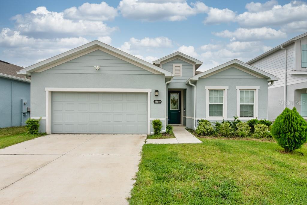 Bright, modern, and thoughtfully designed, this 2023-built Zephyrhills home offers 3 bedrooms, 2 bathrooms, plus a versatile office space—all within 1,823 sq. ft. of open living. Step inside to soaring 10-foot ceilings, elegant French doors, and builder upgrades that include tile flooring throughout (no carpet) for a clean, timeless look. The open-concept layout fills with natural light, creating a seamless flow between the spacious living area, dining nook, and kitchen. At the heart of the home, the kitchen features a large island with breakfast bar seating, a walk-in pantry, and plenty of counter space—perfect for gatherings or everyday living. The true split plan provides privacy with a generous primary suite tucked at the back of the home, complete with a double vanity and walk-in shower. Two additional bedrooms and a full bath sit at the front of the house, making it ideal for family or guests. A dedicated laundry room is conveniently located inside, with a washer and dryer included. Outside, enjoy a fully fenced backyard with crisp white vinyl fencing and room to relax, garden, or entertain. The 2-car garage adds extra storage and convenience. Move-in ready and set in a growing area, this home blends comfort, function, and style in one beautiful package. **Free 1/0 Interest Rate Buy Down when using Melissa Rodriguez with Citywide Home Mortgage - ask Listing Agent for details**