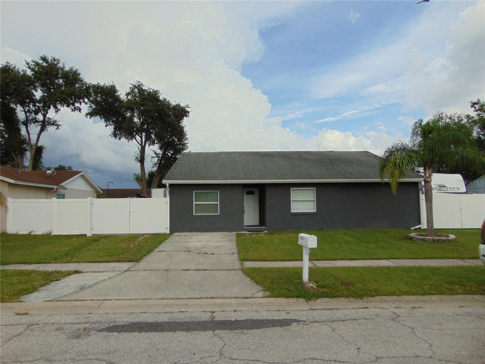 Welcome to Gem House 3 Bed 2 Bath. Additional 1/1 In-Law Suite W/Private Entrance. Great opportunity for a first time home buyer. Great conditions, fresh paint throughout. Nice ceiling fan light wit remote control and reversible blades. Kitchen offers Quartz Countertop a nice Island to enjoy breakfast. Modern Cabinet. Stainless steels appliances. Impact Windows, Enjoy the privacy open porch can be perfect place to spend time with family, BBQ, gatherings or simple relax. Spacious fenced backyard includes a shed for your storage needs. Close to Citrus Park Mall, Veterans Expressway and school. Roof 2018, A/C 2020. Water Heater 2025. Move In Ready!. NO HOA, NO CDD.