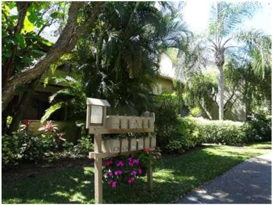 Welcome to this darling 2 bed/2 bath condo!  Pride of ownership beams brightly here -- an updated kitchen including granite countertops and backsplash  Hard wood floors throughout and brand new carpet in the master bedroom.  Note the opened lanai that affords extra living space for friends and family and boasts a fabulous view of the fountain helps to make it private and serene.  The 2nd bedroom is "convertible" and may be used as you wish, open it up for extra living space or close off when needed as a guest suite.   Enclosed laundry room off of lanai is so convenient.... Amenities included in this community that was just rated Best Condominium of 2012 include 24 hour gated security w/ guard, 6 heated pools, 3 clubhouses, 4 lighted tennis courts, shuffleboard, basketball, dog walk area, 87 boat slip harbor, 6 heated swimming pools, 4 tennis courts and 5 miles of walking trails and boardwalks.  This pet friendly resort lifestyle with art studios, social clubs, and exercise classes are just a few of the activities to take part in...This unit is not to be missed...