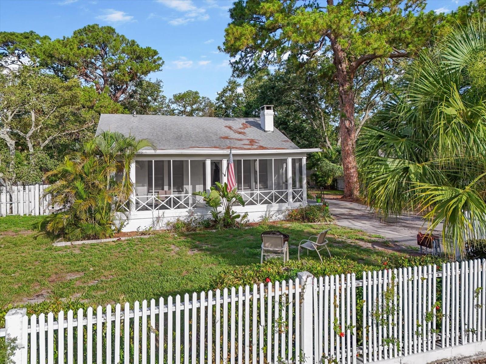 ~Price Refresh!~ CHARMING & HISTORIC, HUGE CORNER LOT...complete with a front porch and picket fence! Step into this 1934 cottage style home that seamlessly blends vintage charm with modern conveniences. Offering 3+ nice size bedrooms and 2-bathrooms, the primary bedroom has original built-ins and a large closet. Nice high ceilings throughout, enjoy morning coffee or game night by the cozy fireplace in the colder months. The spacious eat-in chef's kitchen has a bright and light breakfast nook, currently an office space. You will love having the extra-large laundry and utility room, which adds convenience and functionality. There is so much storage including an oversized walk-in closet that could be converted to a den or additional 4th bedroom with daybed. Another incredible feature is the wrap-around driveway that leads to the expansive 4 car garage that can also be accessed from two separate driveways of the property. The corner 1/2-acre double lot provides plenty of outdoor space for a future pool, while the garage or shop is perfect for hobbies, storage, or working from home. Ample parking for the boat and RV. ++PLUS++...CR ZONING! Permitted uses include; Business or Health Services, Catering, Comparison Goods, Mixed Use/Home occupancy to name a few. Several years ago, it was the headquarters for the Jr. League of Bradenton. It has been beautifully updated in recent years, a new roof in 2019, new air handler in 2021 and so much more. Live in it full time with a home office or shop, rent or Airbnb OR a little of BOTH. The screened front porch, paired with the picturesque picket fence that surrounds the property, invites you to relax and enjoy family and friends. GREAT LOCATION, close to Manatee High and St. Stephen's schools. Bike to downtown Bradenton shops, the farmers market, dining and the Bradenton Riverwalk. Anna Maria Island beaches are only 15 minutes away. Whether you're looking for a unique and timeless home with plenty of character or needed space for hobbies, projects or business, this lovely bungalow checks all the boxes with its old Florida feel! You do not want to miss this one, call to schedule a showing before it is gone!