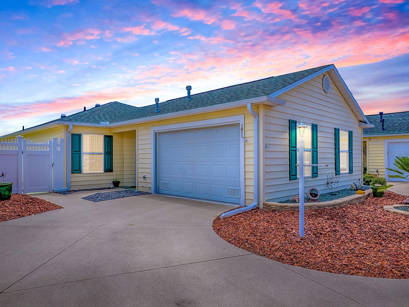 Welcome to this FULLY UPDATED 2-bedroom, 2-bath Courtyard Villa located in Escondido Villas near the Savannah Center. You're just a short golf cart ride from both Lake Sumter Landing and Spanish Springs Town Squares, giving you easy access to dining, shopping, and nightly entertainment. Inside, this home features luxury vinyl plank flooring throughout with beautiful ceramic tile in the kitchen & baths, custom cornice boards throughout, and a stylish, updated kitchen with newer appliances, cabinetry, and upgraded countertops. The primary suite offers a spa-like retreat with an upgraded walk-in shower and frameless glass door, and walk-in closet with custom shelving. Enjoy year-round comfort in the enclosed, air-conditioned Florida room—perfect for relaxing or entertaining. Additional Highlights: Roof (2017), HVAC (2022),Tankless Water Heater (2025), and new kitchen cabinets, counters & appliances (2020). Enjoy fabulous remote controlled awnings for both side and rear patio areas. NO BOND, NO GRASS – low-maintenance landscaping. This villa offers carefree Florida living at its best—MOVE-IN READY and BEAUTIFULLY MAINTAINED. Schedule your private showing today!